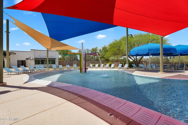 a view of a patio with a table and chairs under an umbrella