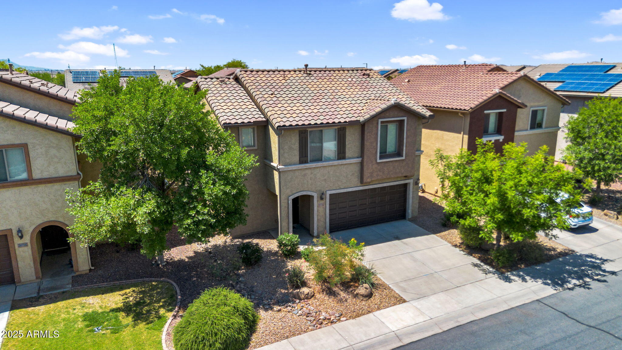 8071 West Georgetown Way Florence, AZ 85132 - Photo 41 of 43 a front view of a house with a yard and a garden