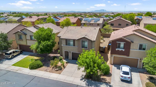 an aerial view of multiple houses with a yard