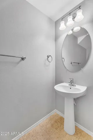 a bathroom with a sink a mirror and vanity