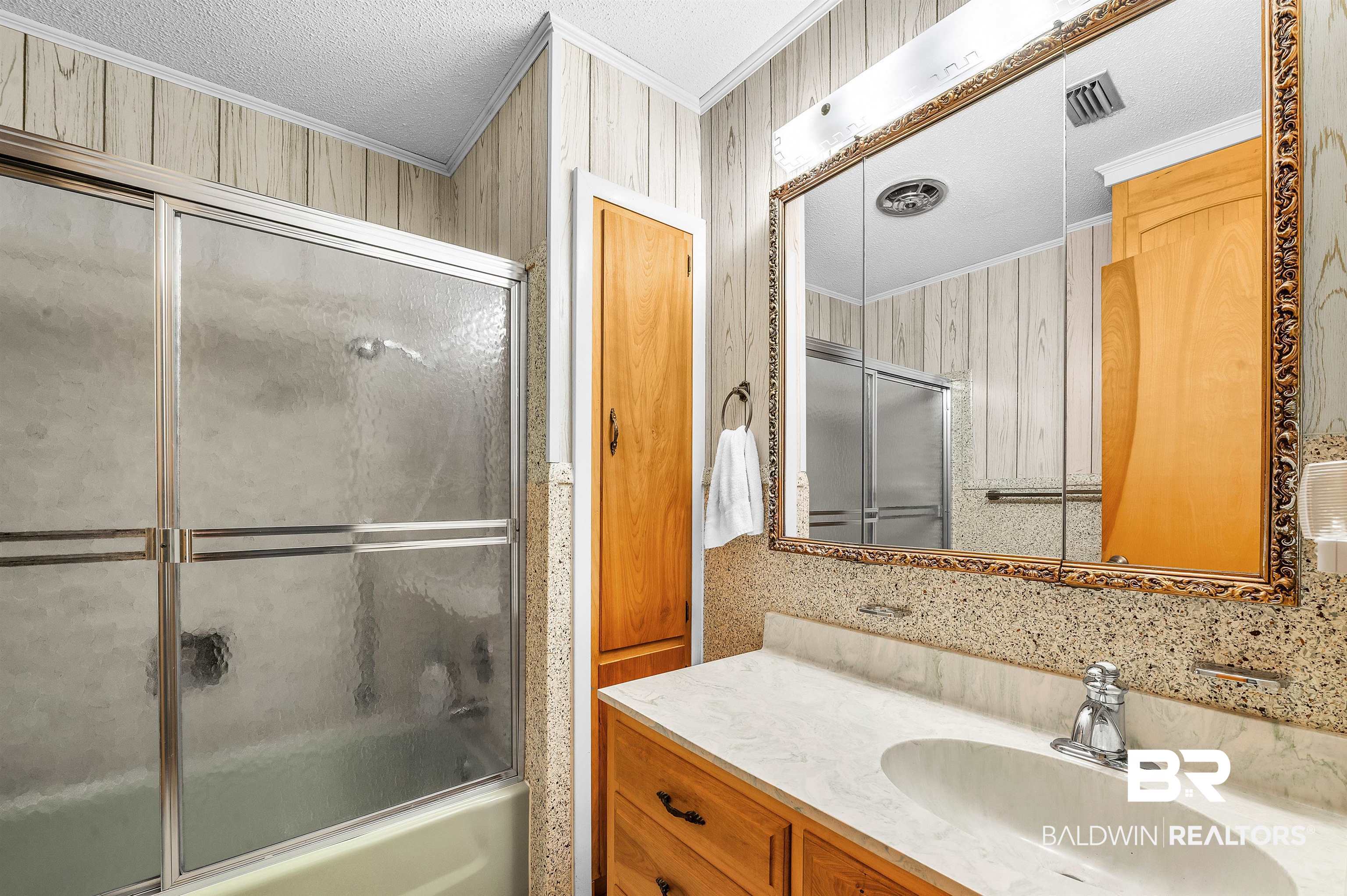 610 East Walker Avenue Foley, AL 36535 - Photo 26 of 38 Full bath featuring ornamental molding, vanity, enclosed tub / shower combo, and a textured ceiling
