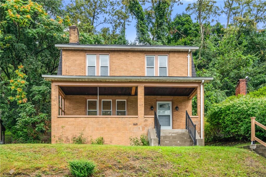 a front view of a house with garden