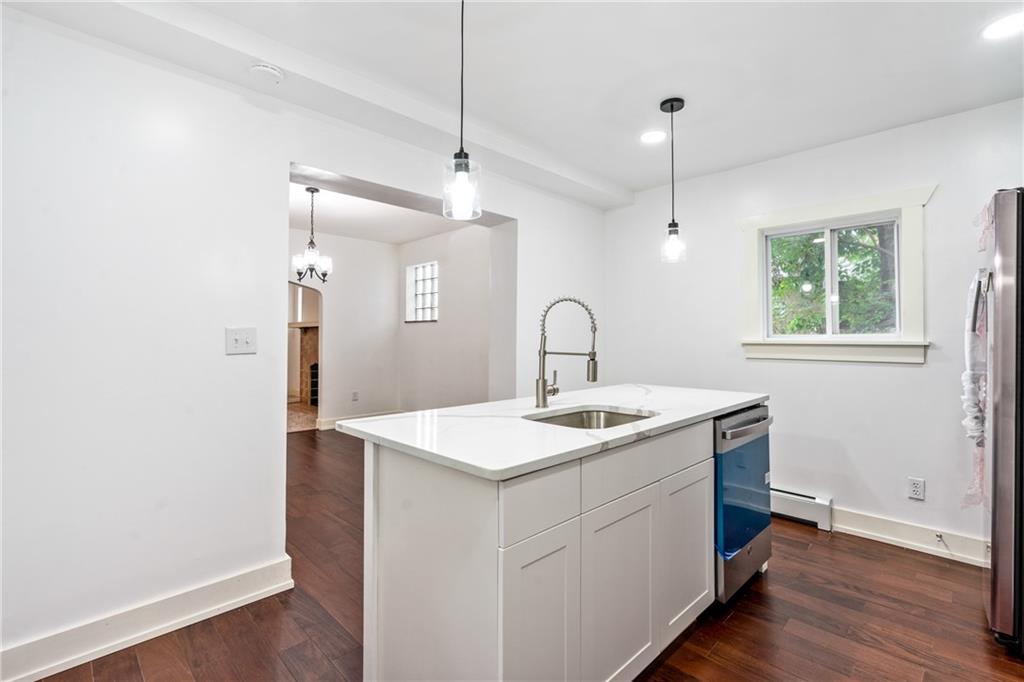 8619 Westwood Road Pittsburgh, PA 15235 - Photo 13 of 26 a kitchen with a sink a counter space and wooden floor