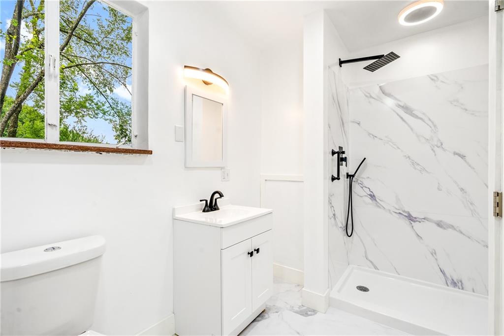 8619 Westwood Road Pittsburgh, PA 15235 - Photo 14 of 26 a bathroom with a sink a toilet and shower
