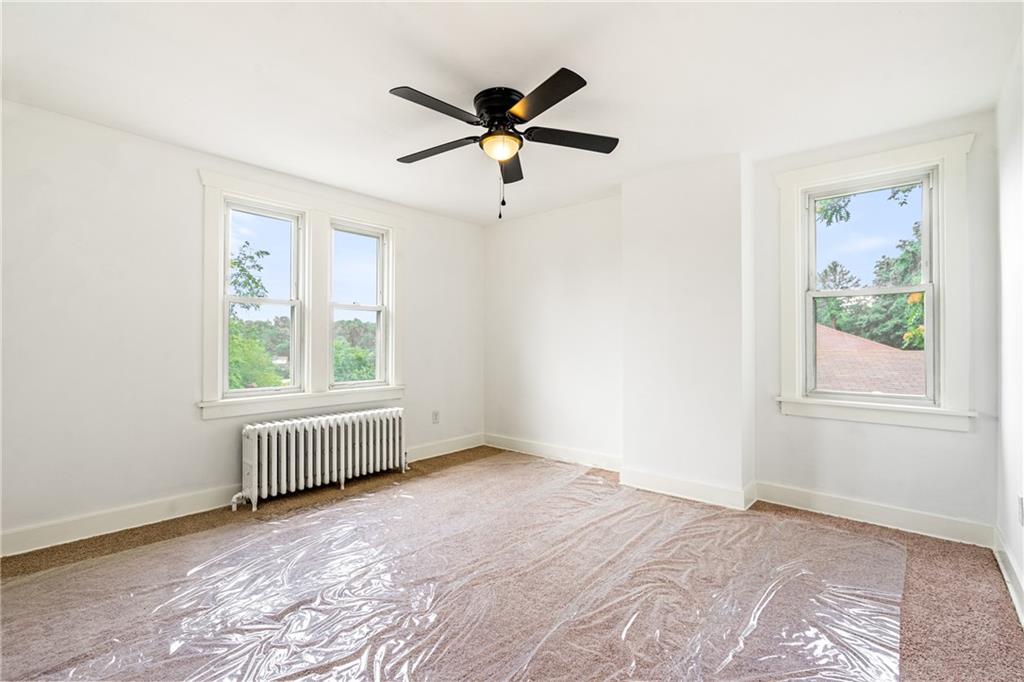 8619 Westwood Road Pittsburgh, PA 15235 - Photo 19 of 26 a view of empty room with wooden floor and fan