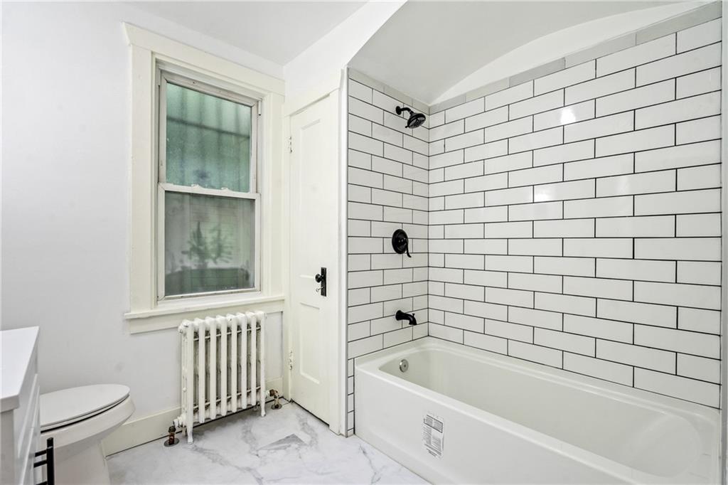 8619 Westwood Road Pittsburgh, PA 15235 - Photo 21 of 26 a bathroom with a bathtub and a toilet