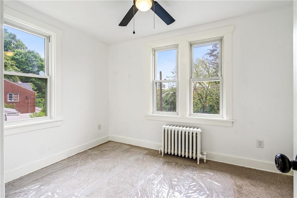 8619 Westwood Road Pittsburgh, PA 15235 - Photo 22 of 26 an empty room with windows