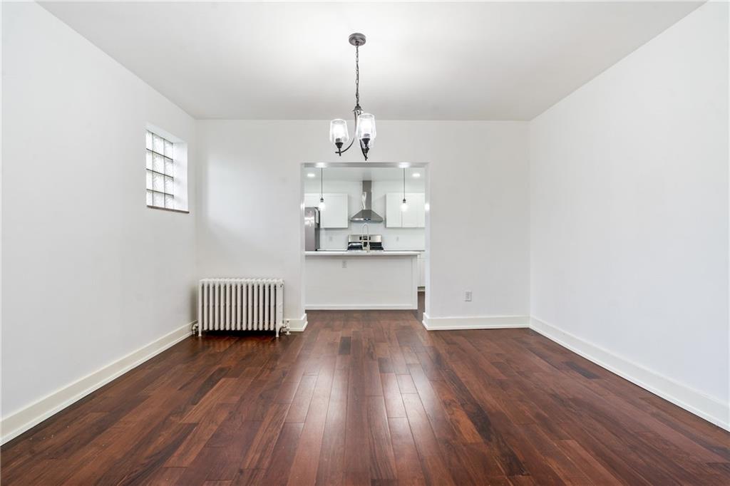 8619 Westwood Road Pittsburgh, PA 15235 - Photo 8 of 26 a view of a room with wooden floor chandelier and window
