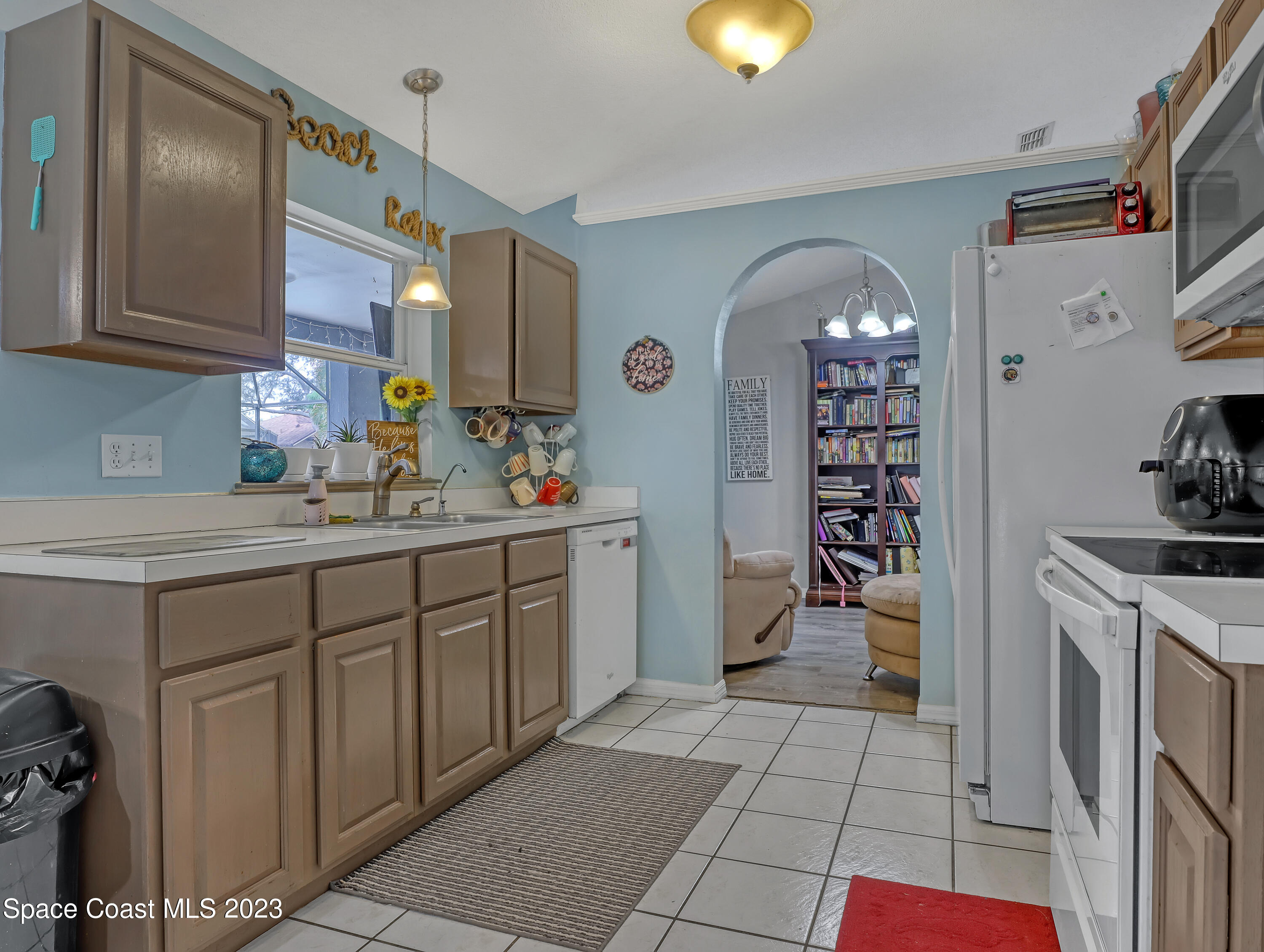 2305 Shady Oak Road Melbourne, FL 32935 - Photo 12 of 38 a kitchen with a sink and cabinets