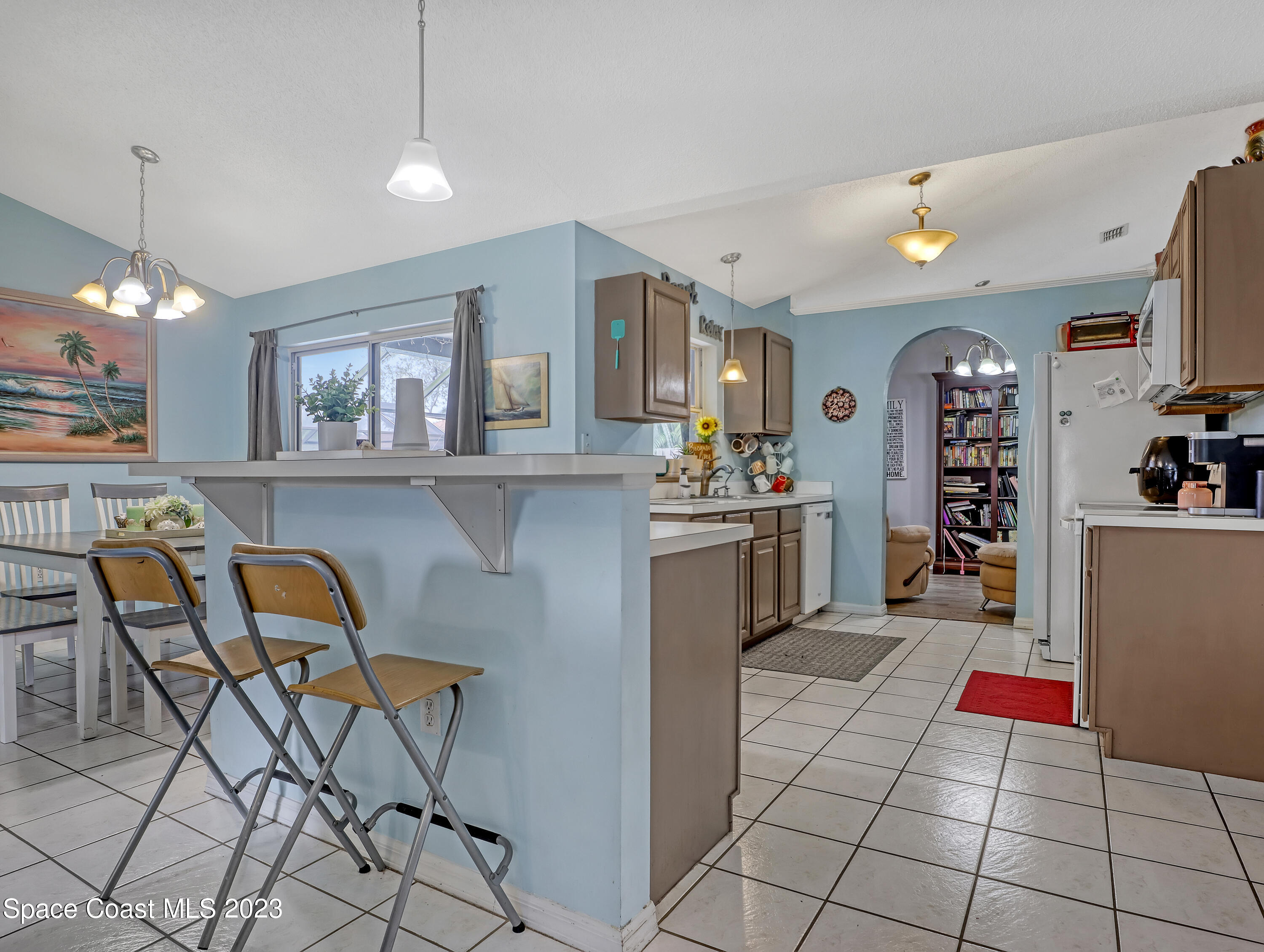 2305 Shady Oak Road Melbourne, FL 32935 - Photo 14 of 38 a view of kitchen with cabinets and outdoor dining space