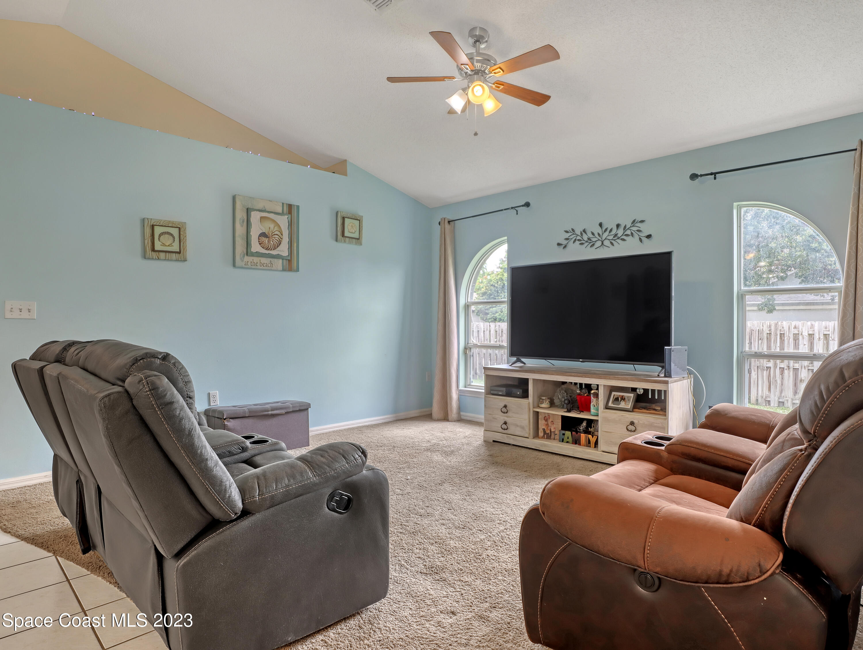2305 Shady Oak Road Melbourne, FL 32935 - Photo 18 of 38 a living room with furniture and a flat screen tv