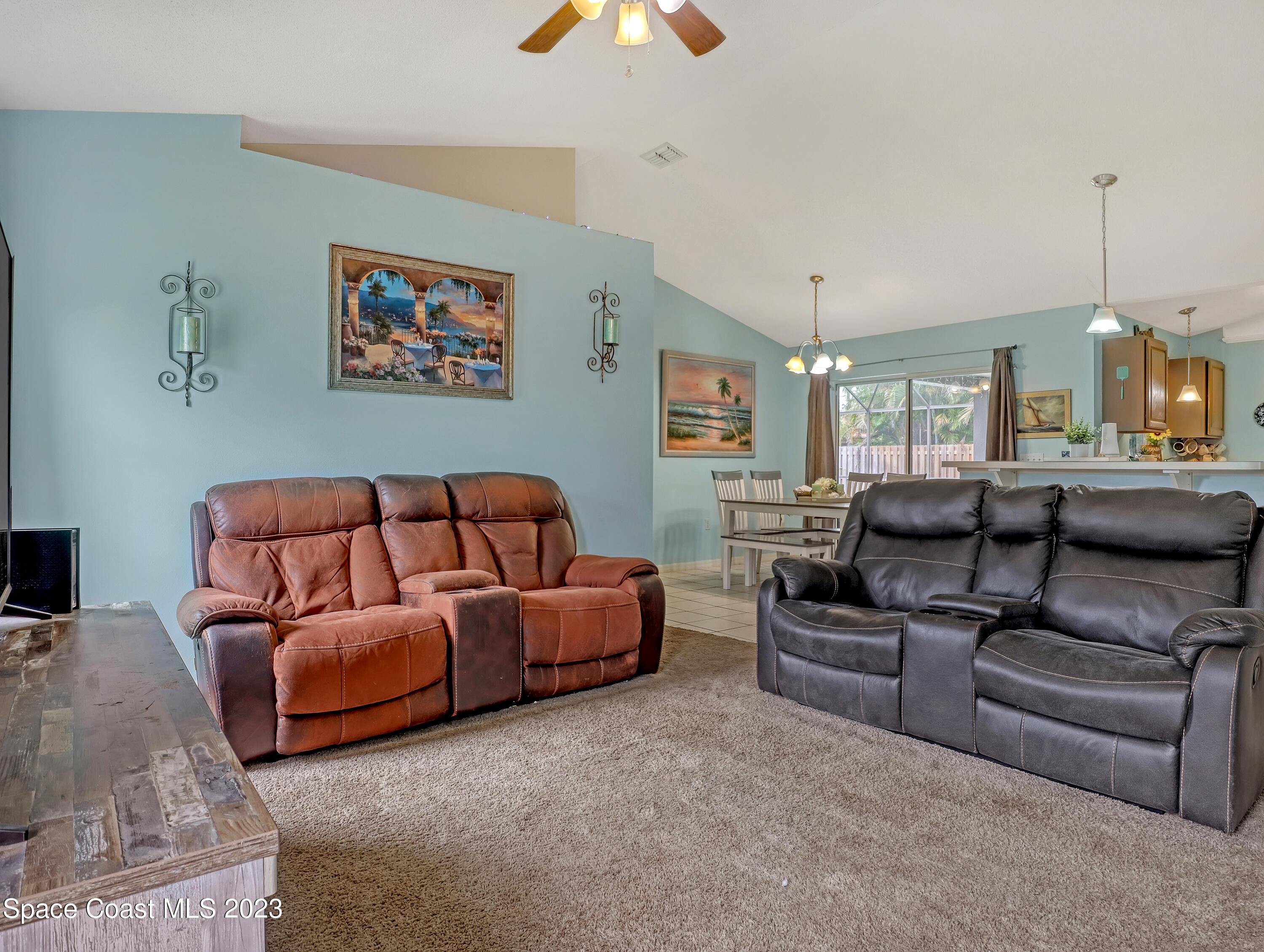 2305 Shady Oak Road Melbourne, FL 32935 - Photo 19 of 38 a living room with furniture and a chandelier