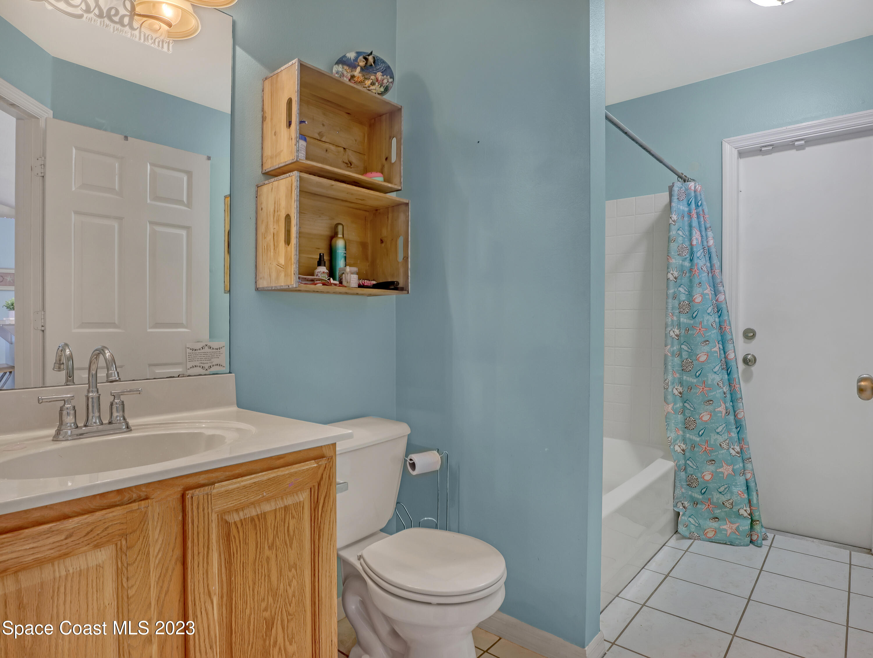 2305 Shady Oak Road Melbourne, FL 32935 - Photo 20 of 38 a bathroom with a granite countertop sink toilet and shower