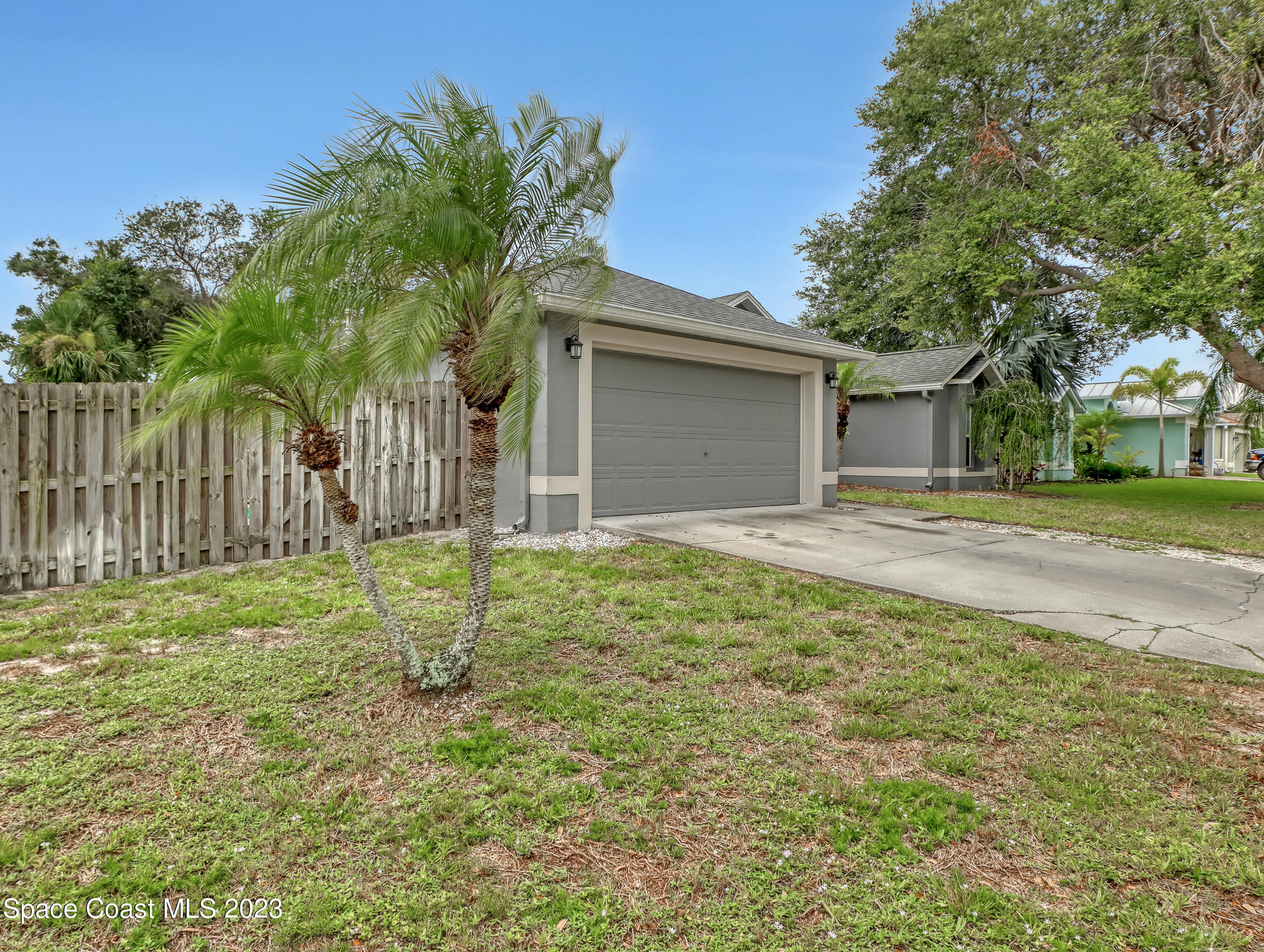 2305 Shady Oak Road Melbourne, FL 32935 - Photo 2 of 38 a house that has a tree in front of it
