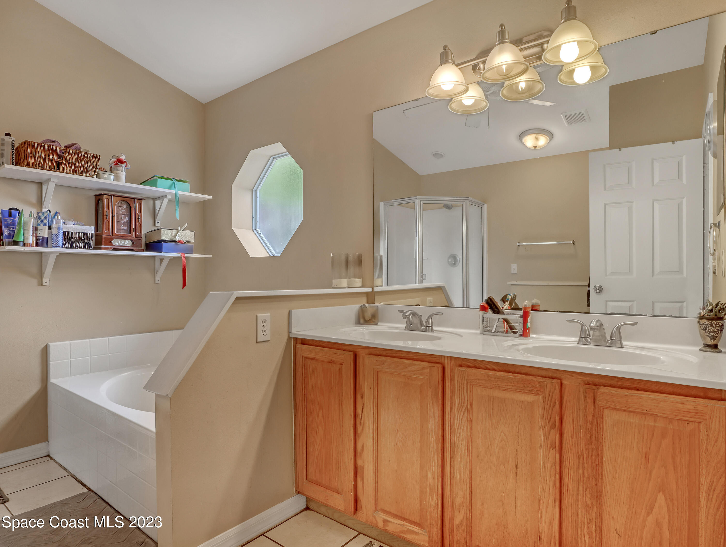 2305 Shady Oak Road Melbourne, FL 32935 - Photo 23 of 38 a bathroom with a double vanity sink and a mirror