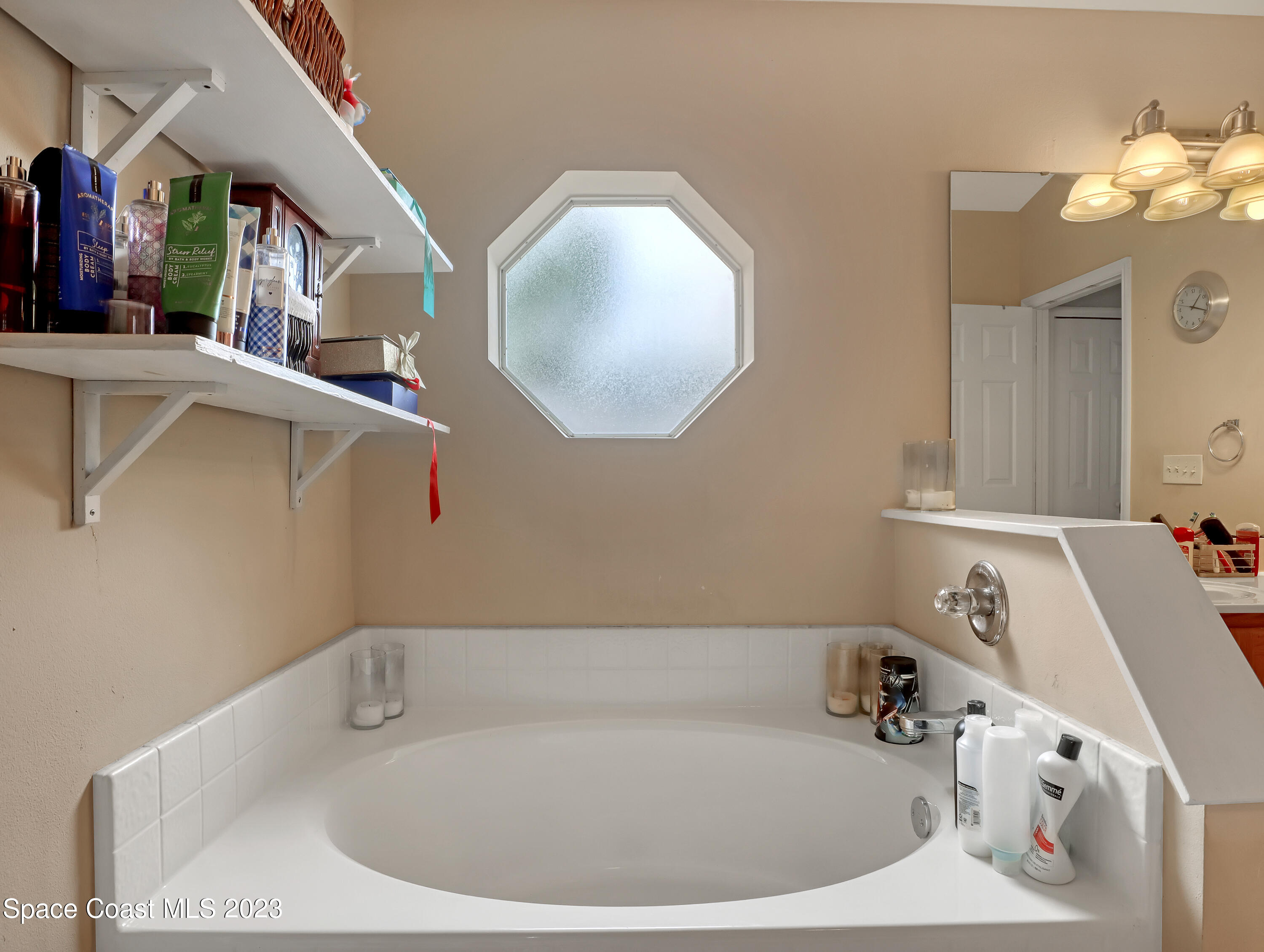 2305 Shady Oak Road Melbourne, FL 32935 - Photo 24 of 38 a bathroom with a tub sink and mirror