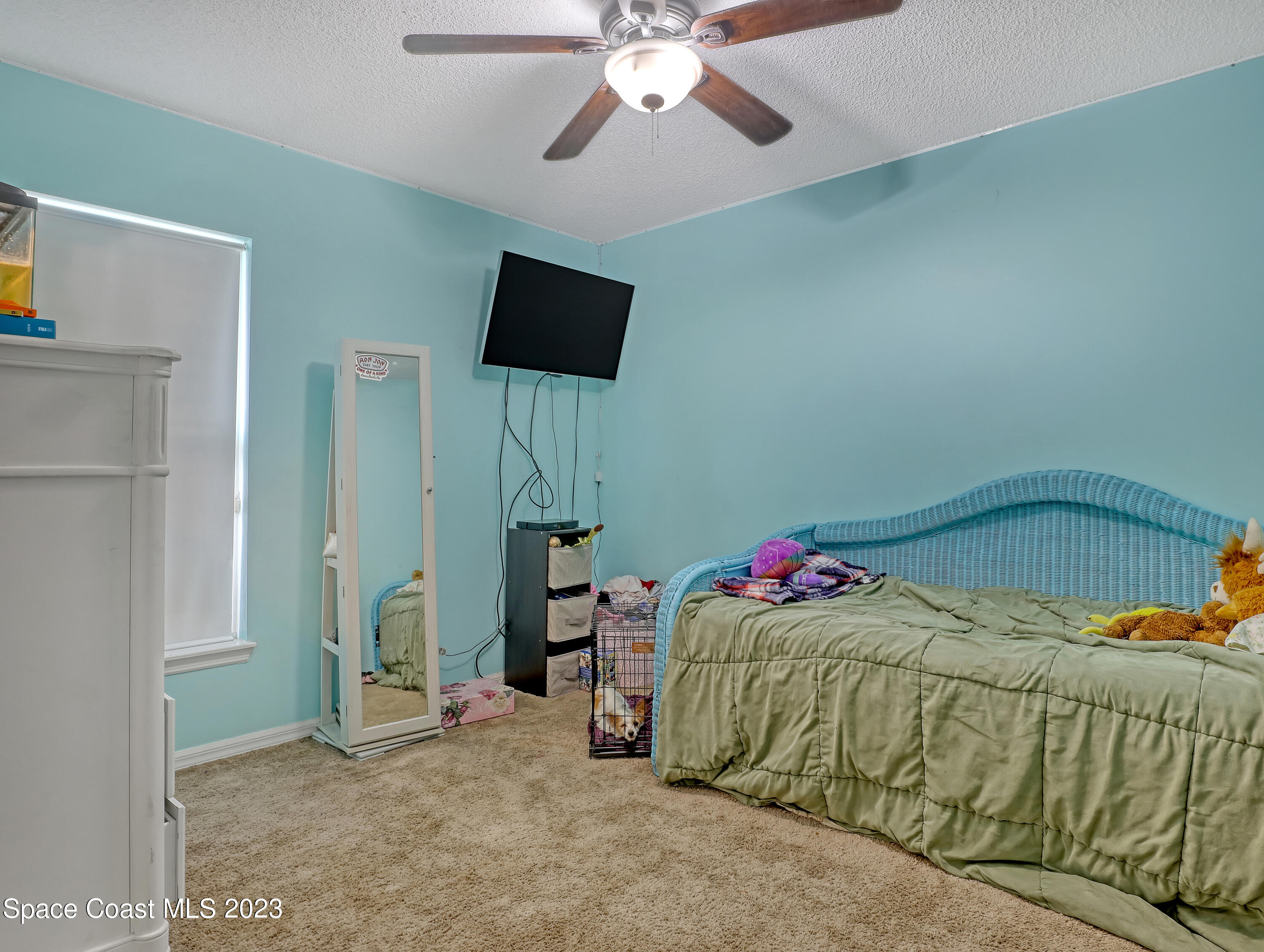 2305 Shady Oak Road Melbourne, FL 32935 - Photo 26 of 38 a living room with a couch and a ceiling fan