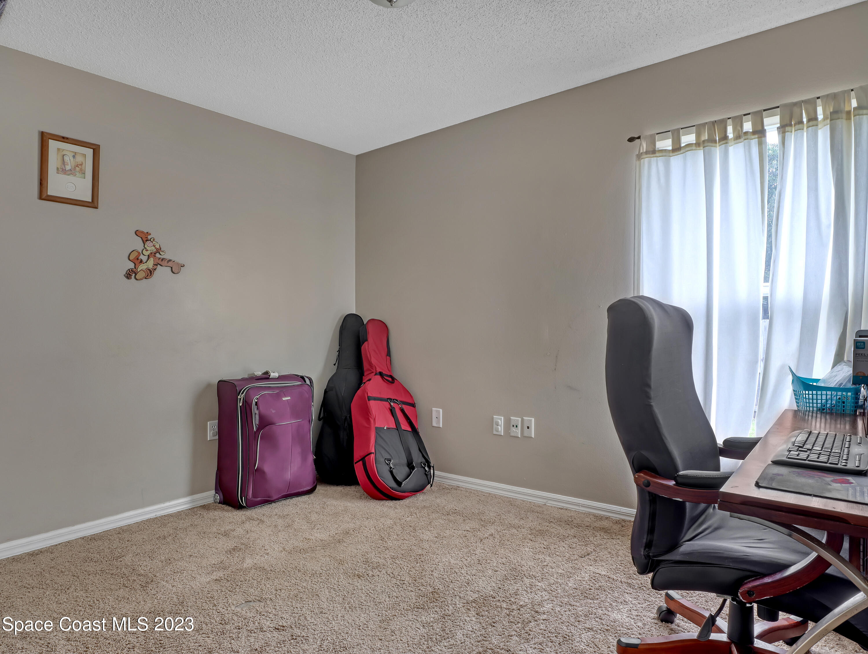 2305 Shady Oak Road Melbourne, FL 32935 - Photo 28 of 38 a view of a workspace with furniture and a window