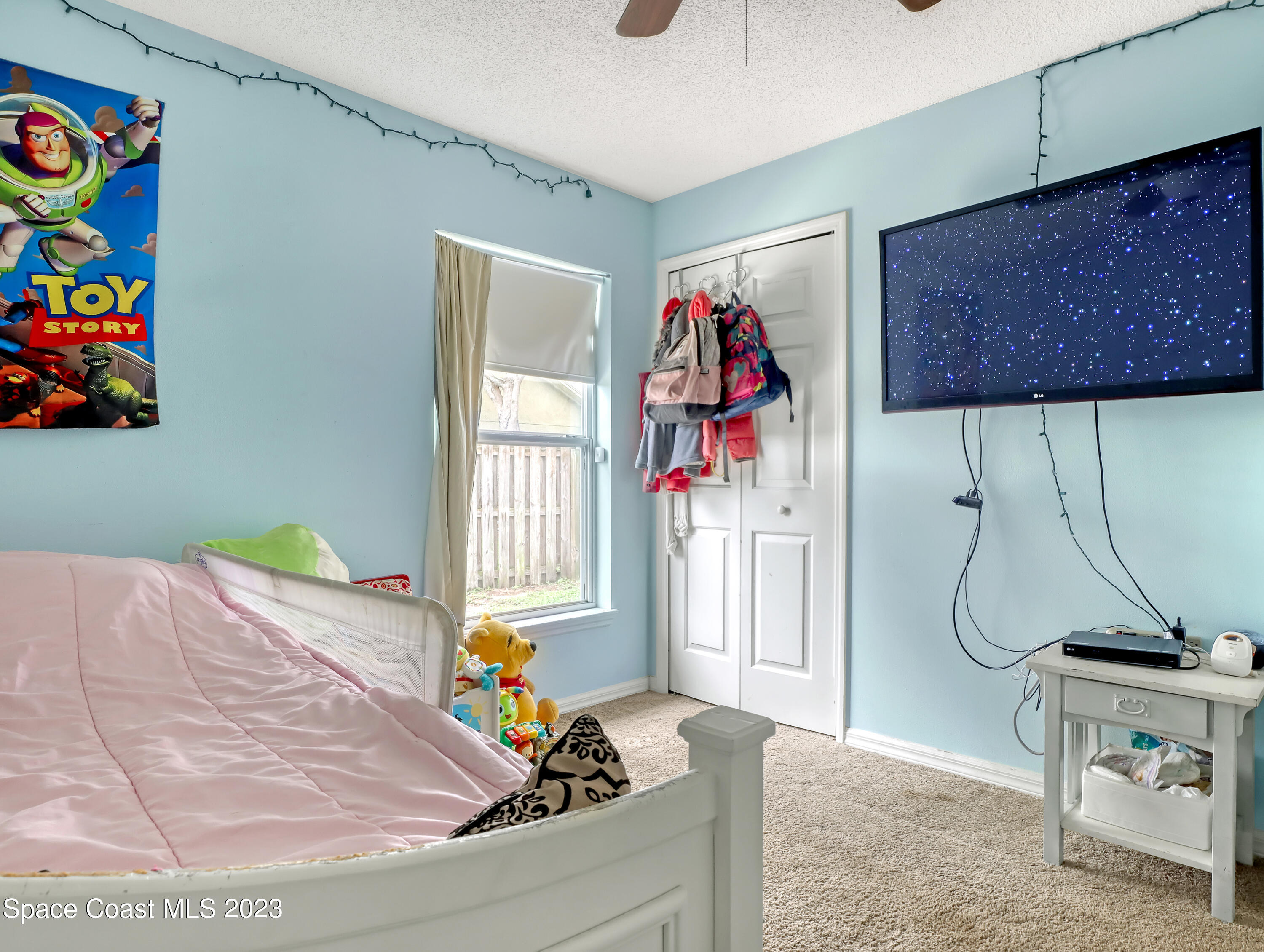 2305 Shady Oak Road Melbourne, FL 32935 - Photo 30 of 38 a bed room with a bed and a window