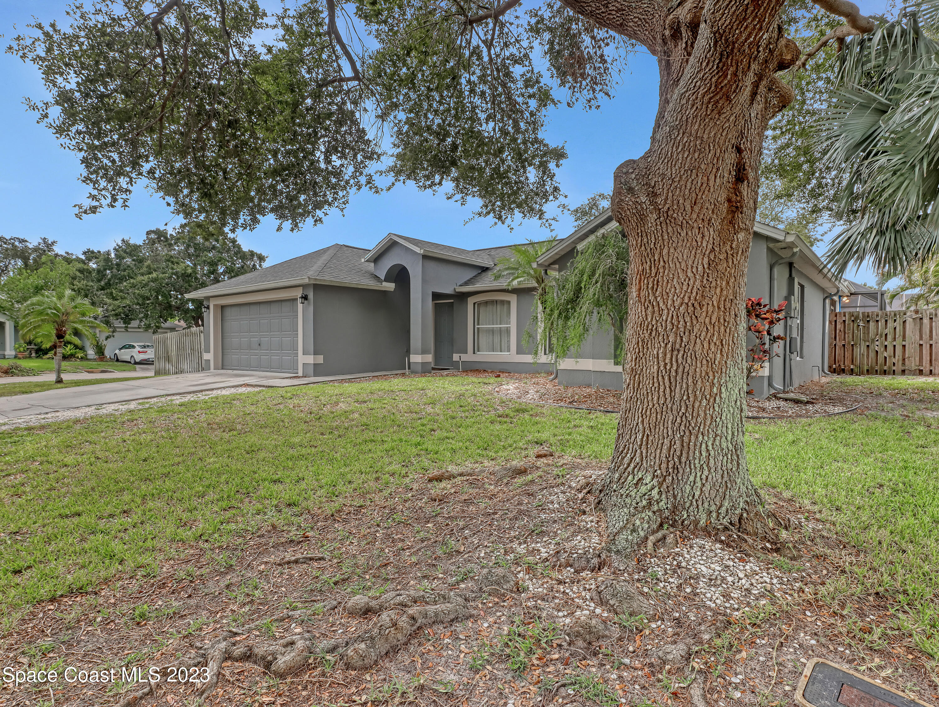 2305 Shady Oak Road Melbourne, FL 32935 - Photo 3 of 38 a front view of a house with garden