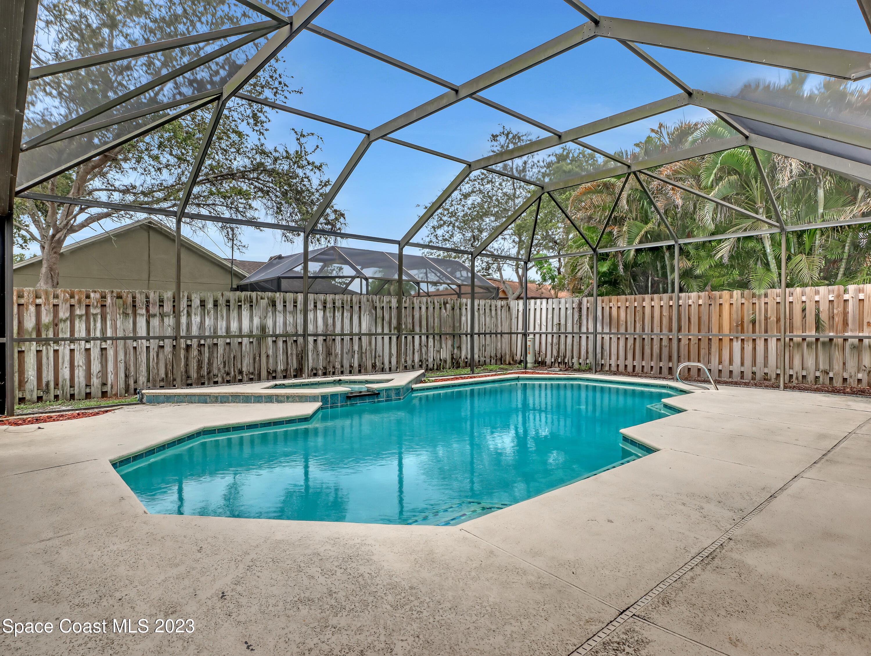 2305 Shady Oak Road Melbourne, FL 32935 - Photo 33 of 38 a view of a swimming pool with a backyard