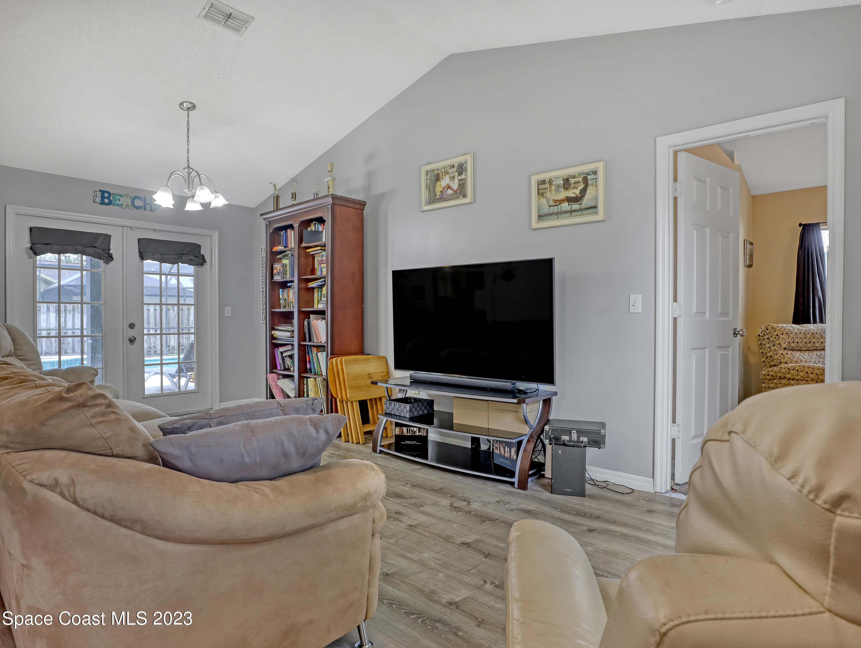 2305 Shady Oak Road Melbourne, FL 32935 - Photo 7 of 38 a living room with furniture and a flat screen tv