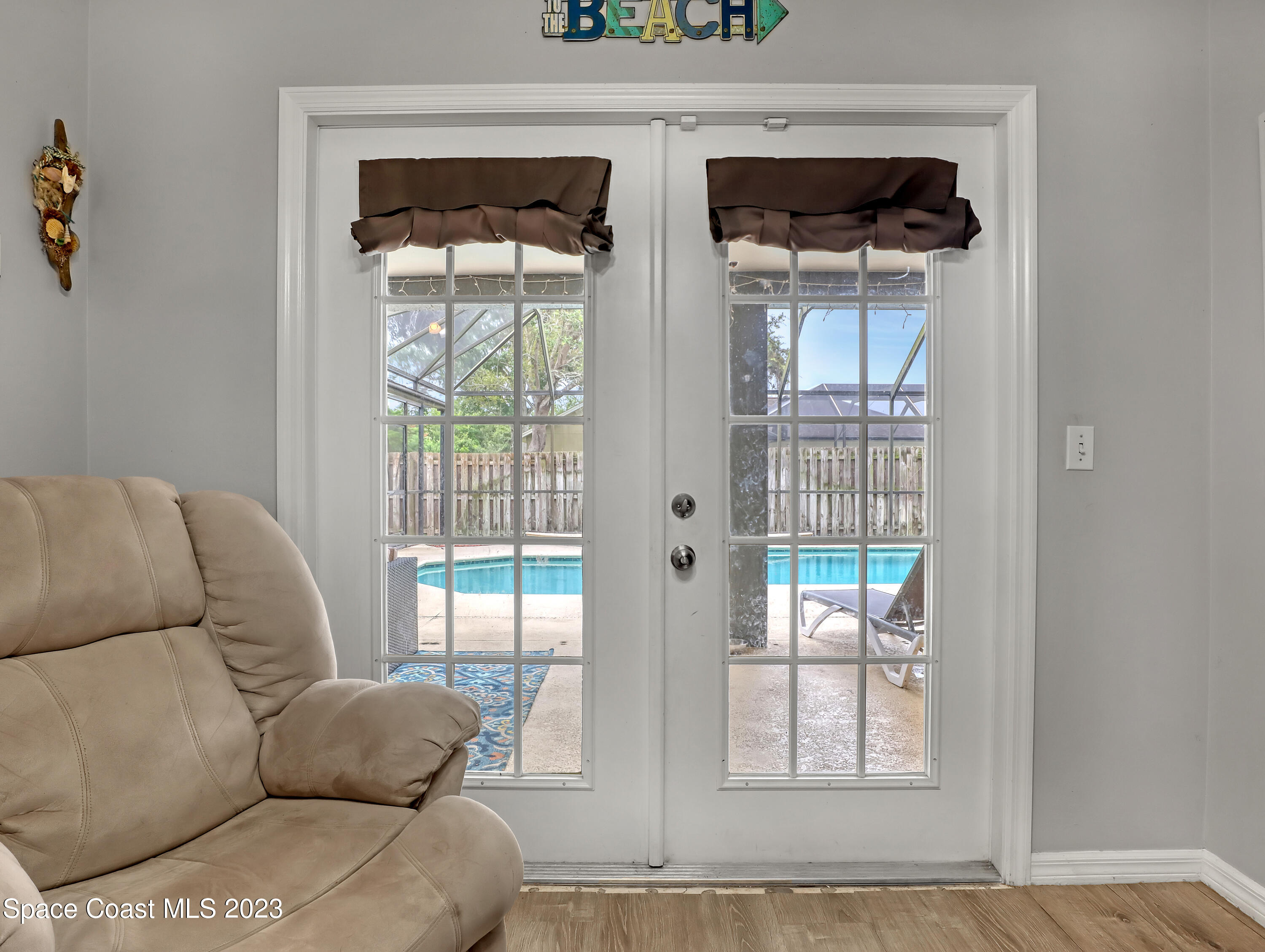 2305 Shady Oak Road Melbourne, FL 32935 - Photo 9 of 38 a living room with furniture and a floor to ceiling window