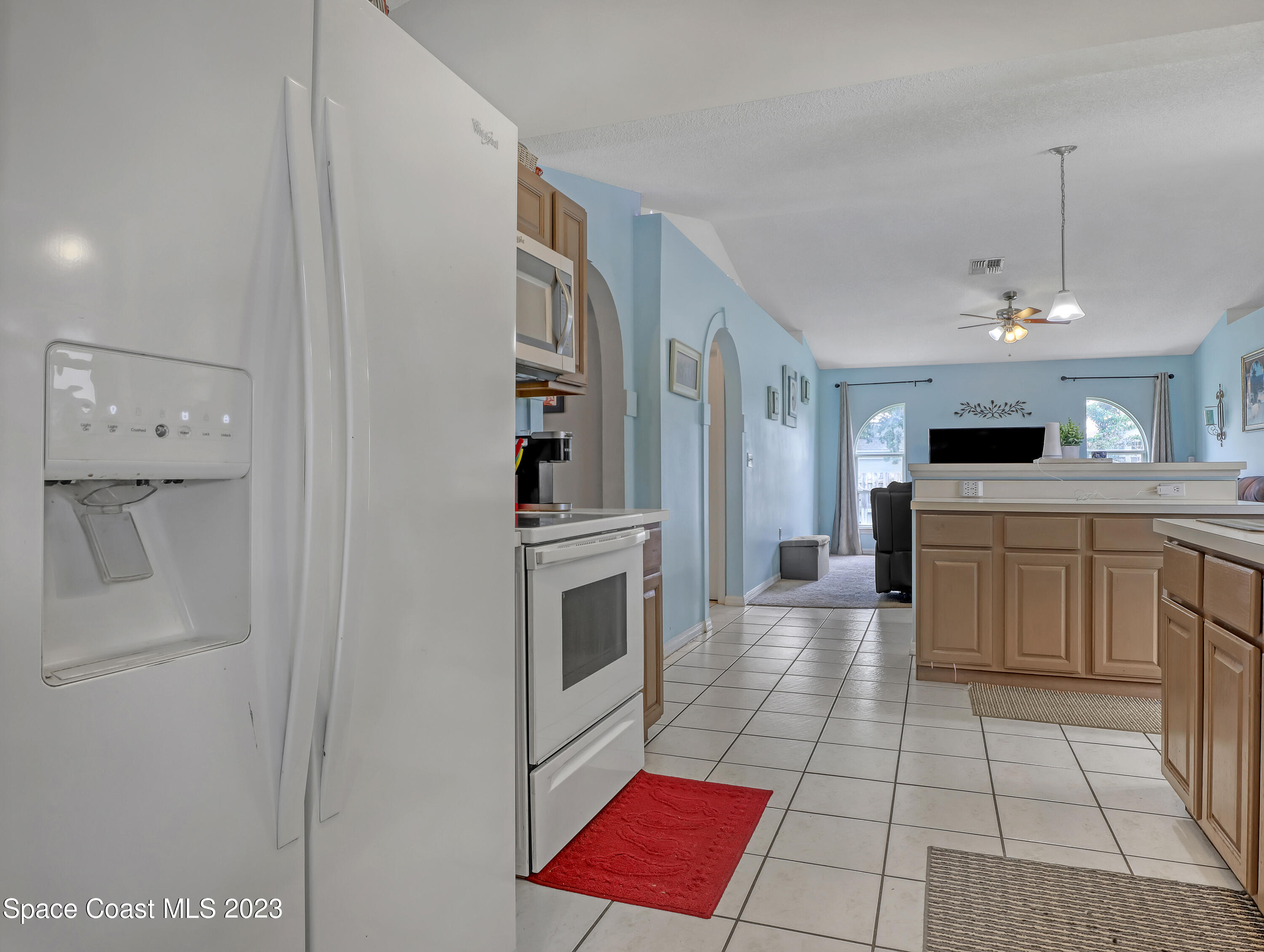 2305 Shady Oak Road Melbourne, FL 32935 - Photo 10 of 38 a large white kitchen with cabinets and stainless steel appliances