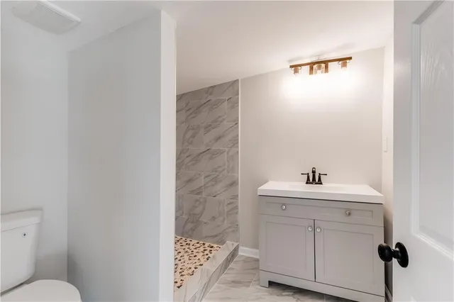 a bathroom with a sink toilet and mirror