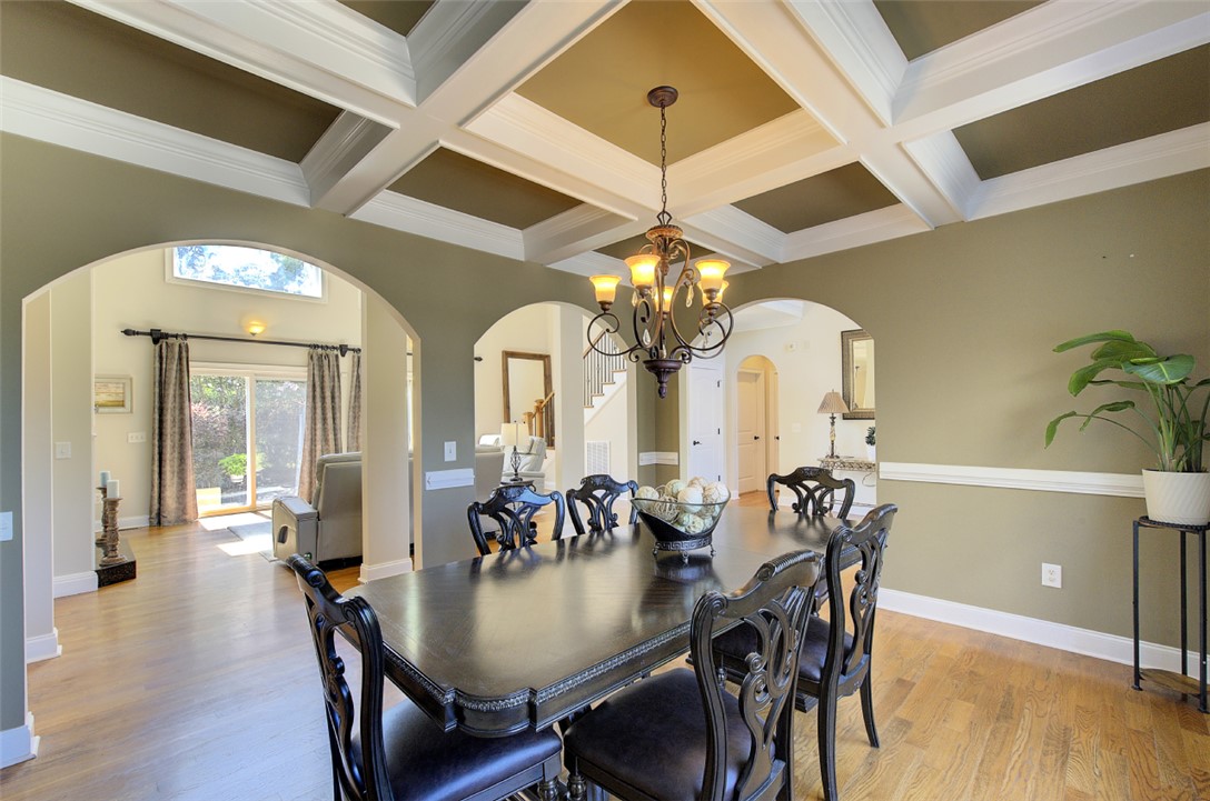 100 Turnberry Road Anderson, SC 29621 - Photo 6 of 41 Coffered ceilings and arched doorways define this elegant dining space with hardwood floors.