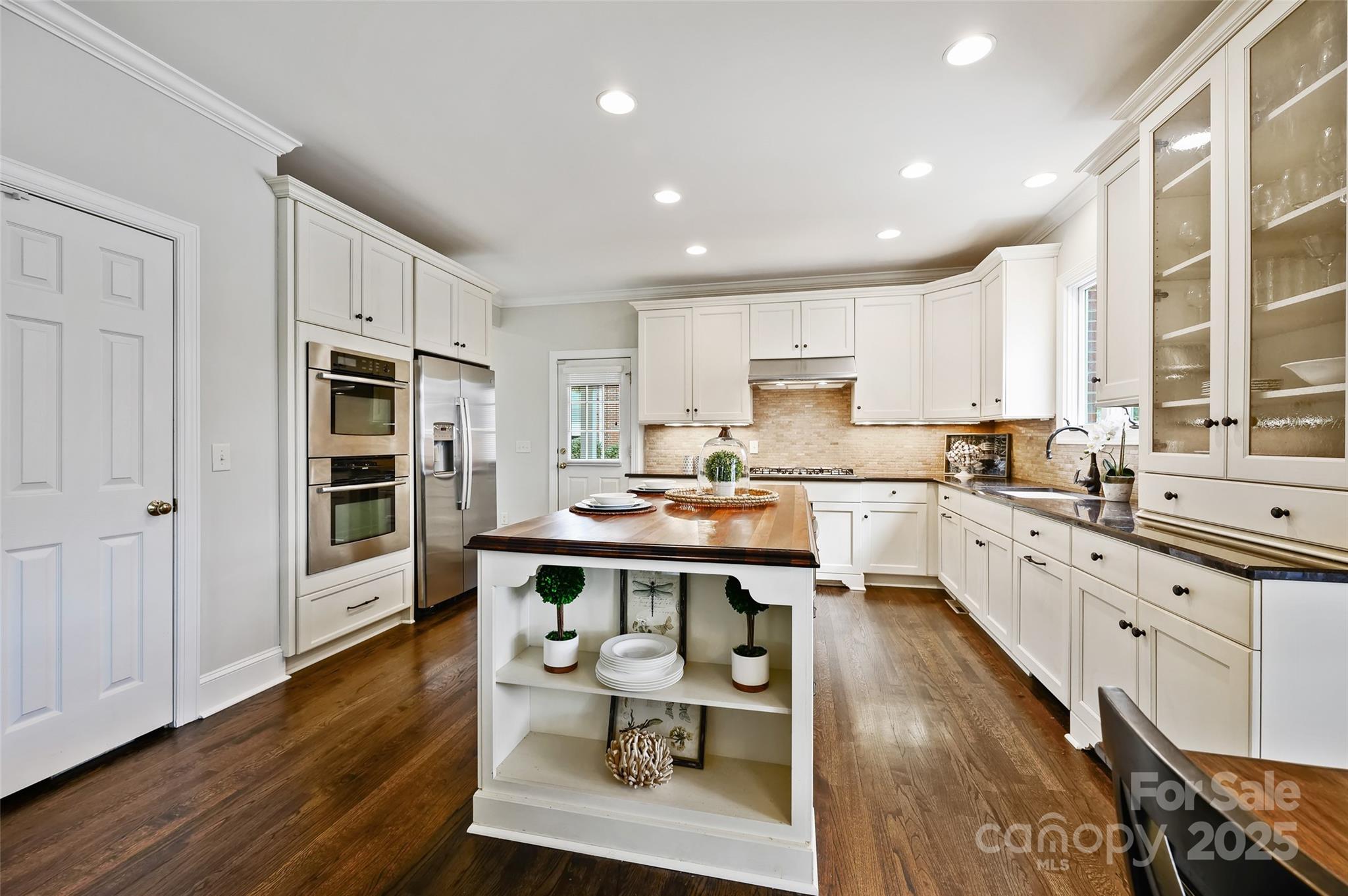 7704 Sharpthorne Place Charlotte, NC 28270 - Photo 12 of 34 a large kitchen with kitchen island a dining table and chairs