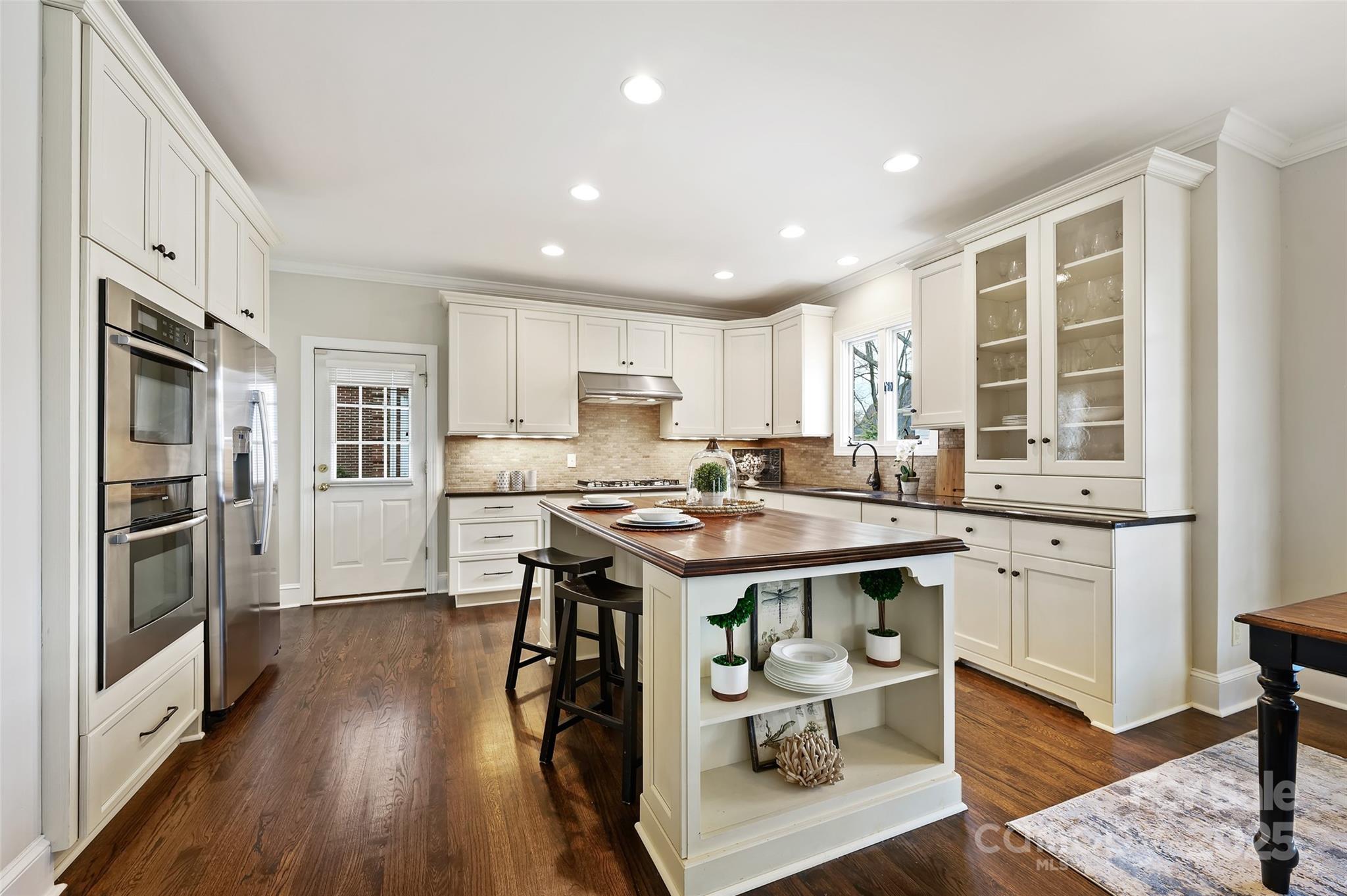 7704 Sharpthorne Place Charlotte, NC 28270 - Photo 13 of 34 a kitchen with stainless steel appliances granite countertop a table chairs refrigerator and sink