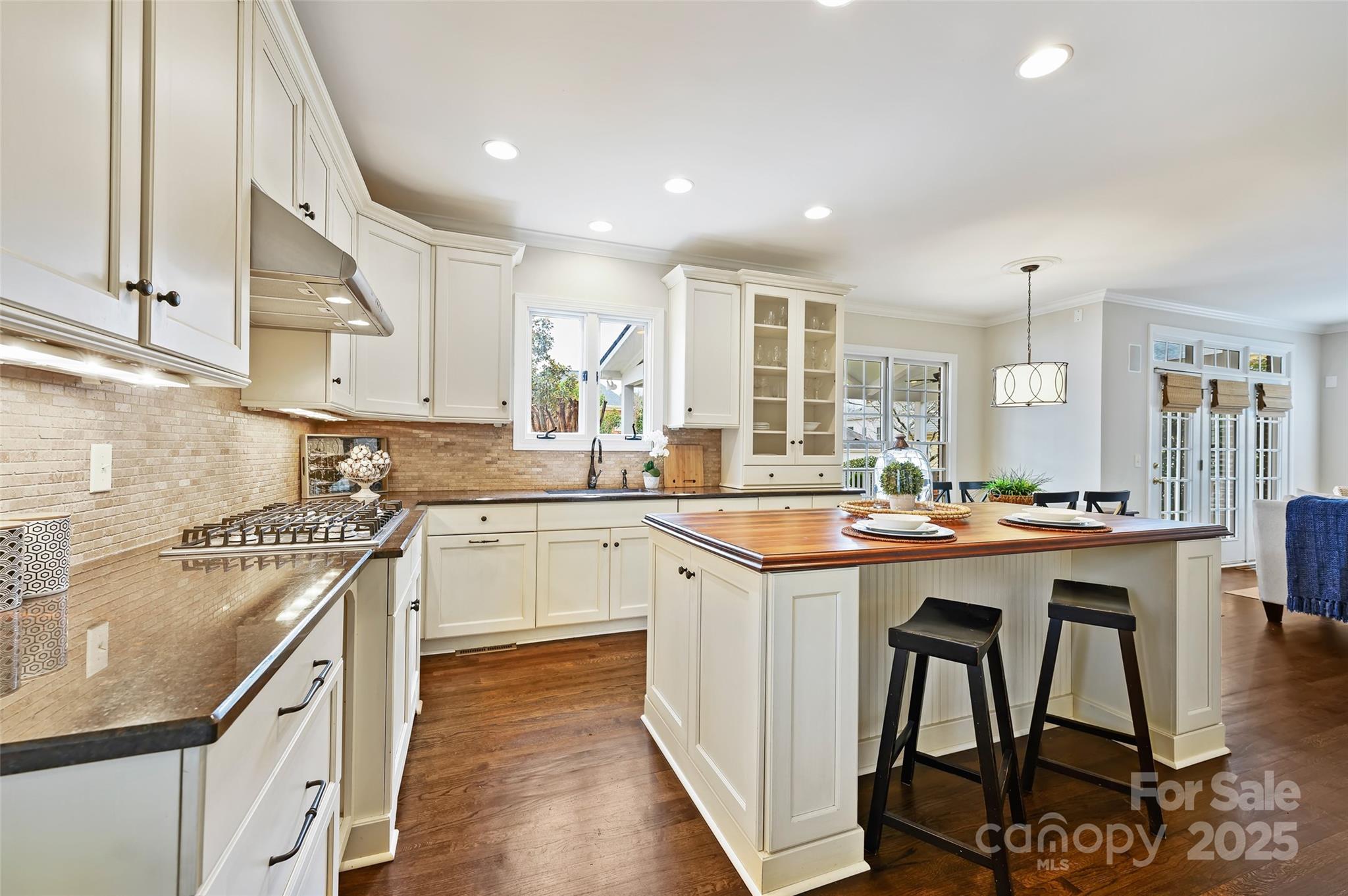 7704 Sharpthorne Place Charlotte, NC 28270 - Photo 14 of 34 a kitchen with a sink stove cabinets and chairs