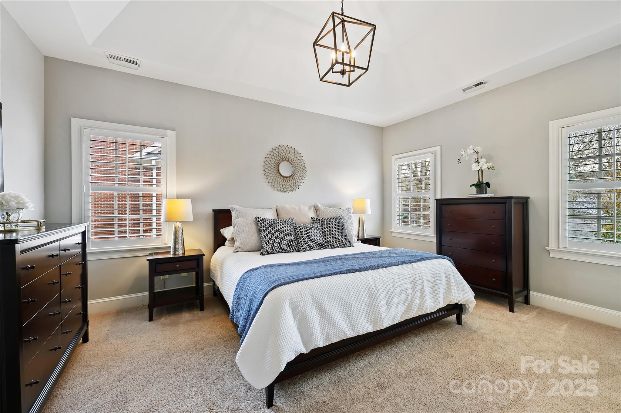 7704 Sharpthorne Place Charlotte, NC 28270 - Photo 19 of 34 a bedroom with a bed and a chandelier