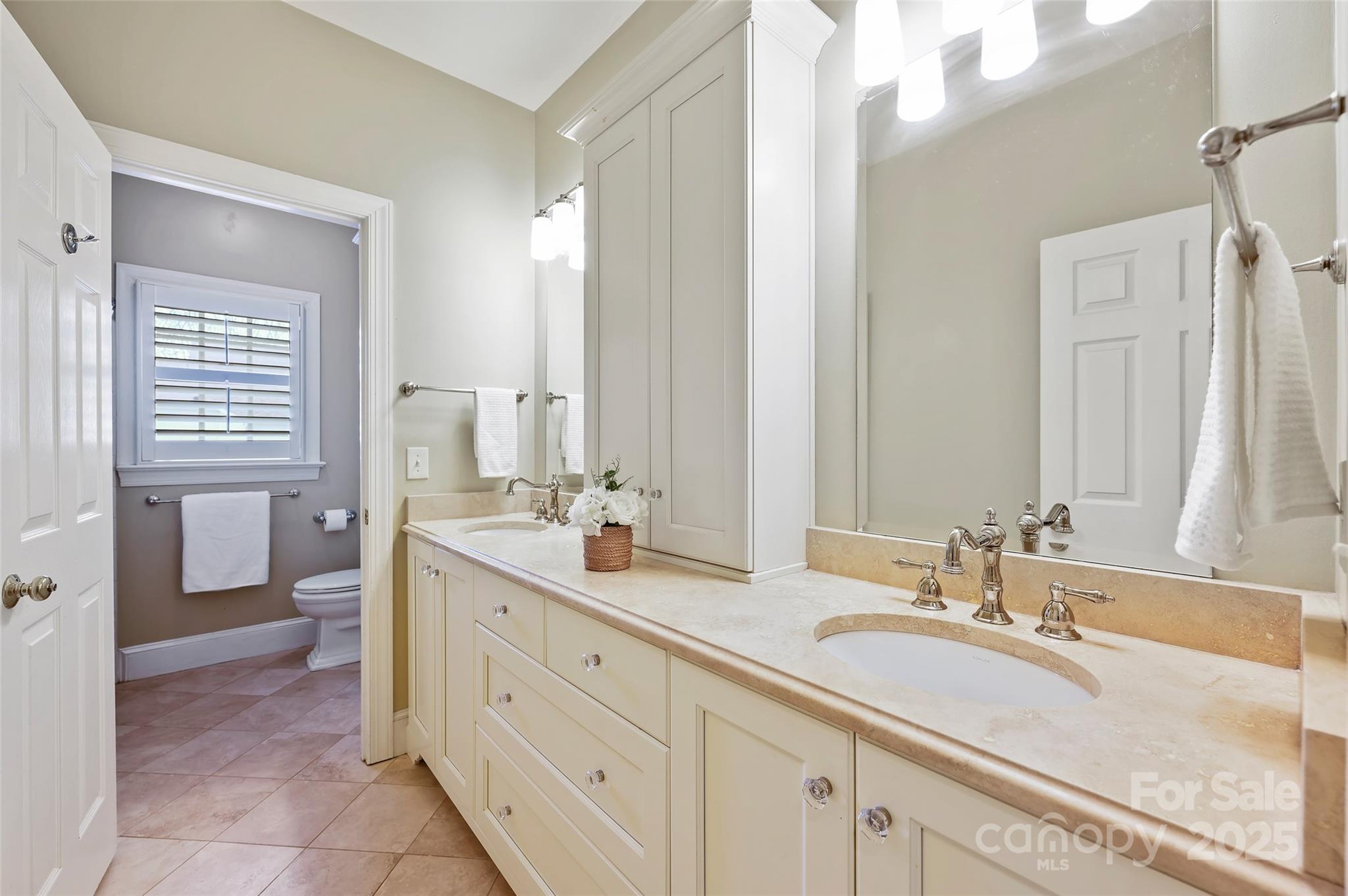 7704 Sharpthorne Place Charlotte, NC 28270 - Photo 23 of 34 a spacious bathroom with double sink and a mirror