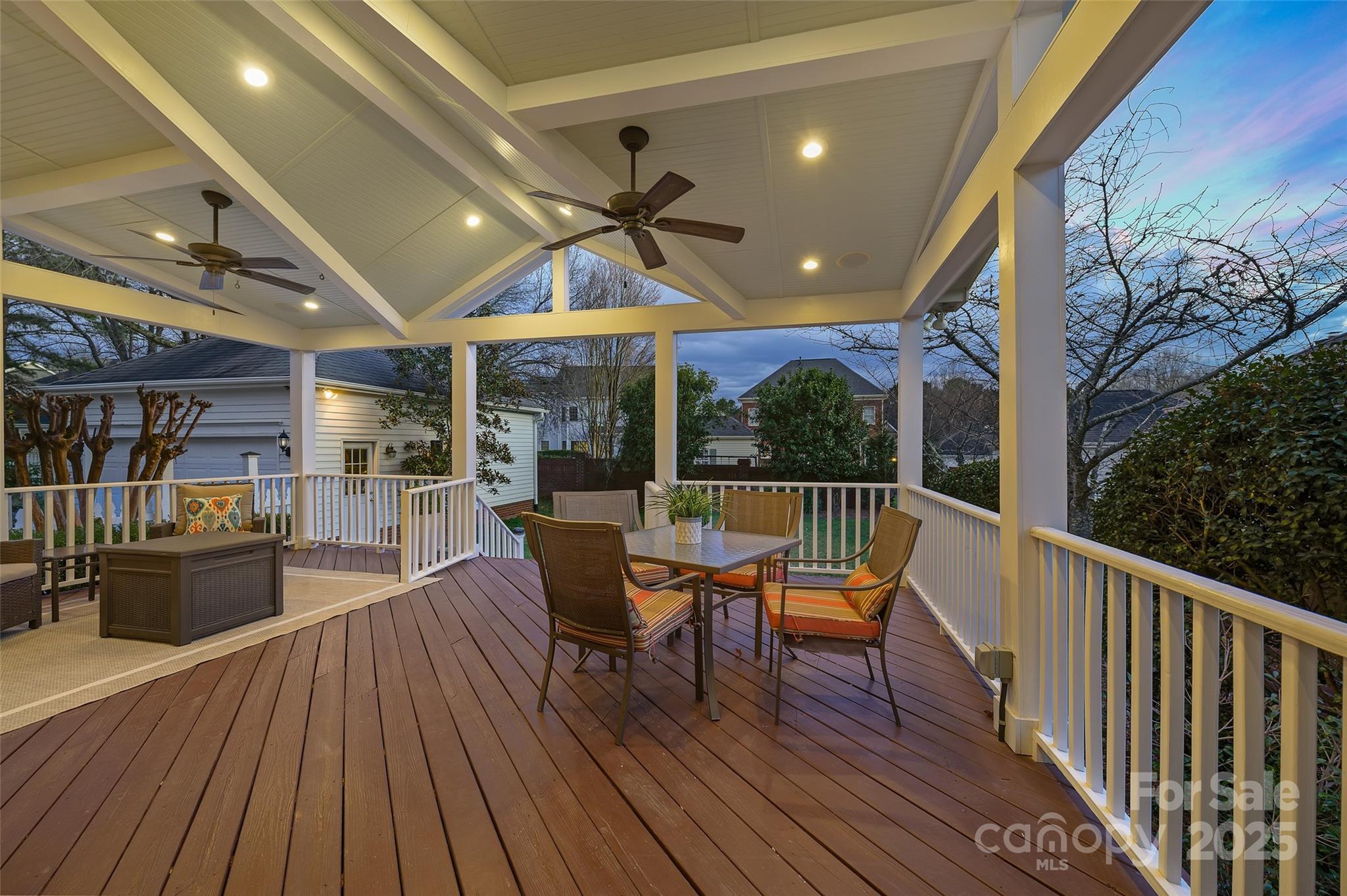 7704 Sharpthorne Place Charlotte, NC 28270 - Photo 27 of 34 a view of a patio with a dining table and chairs with wooden floor