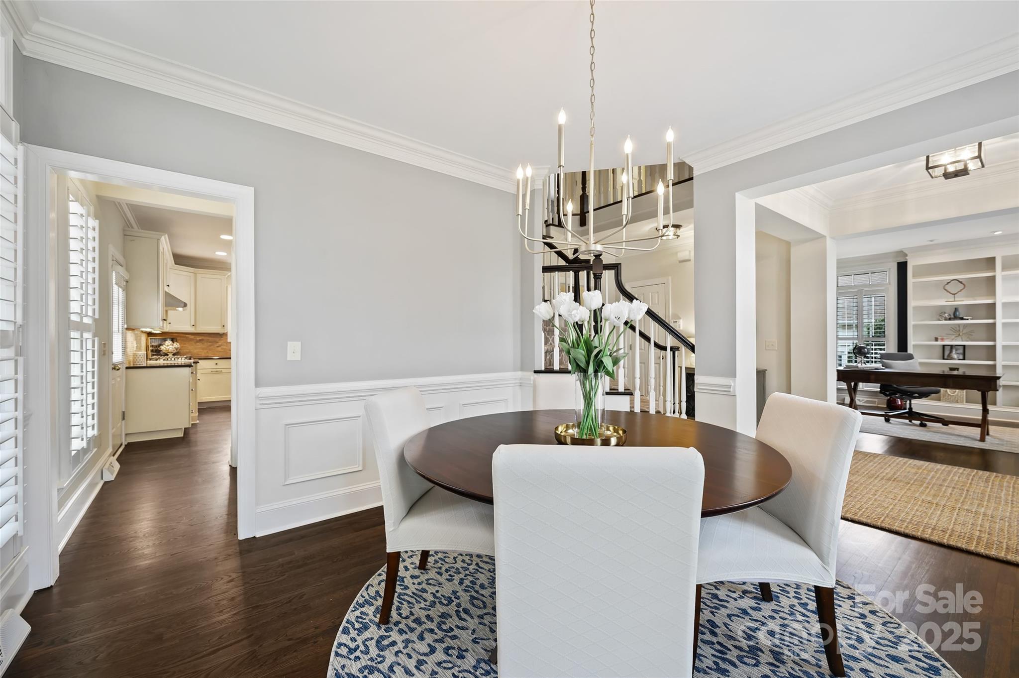 7704 Sharpthorne Place Charlotte, NC 28270 - Photo 8 of 34 a living room with furniture and a chandelier