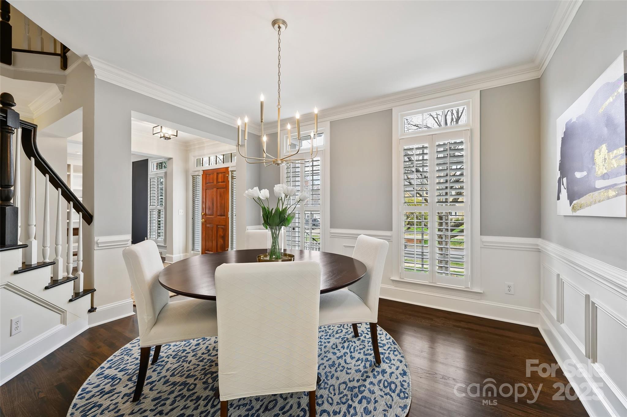 7704 Sharpthorne Place Charlotte, NC 28270 - Photo 10 of 34 a living room with furniture and a chandelier