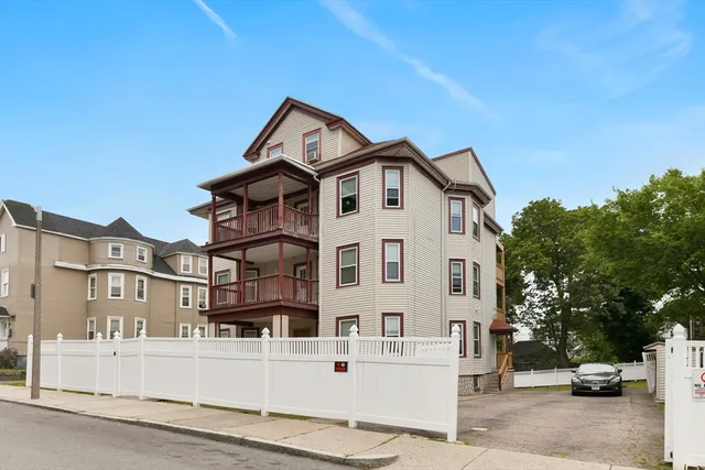 a view of a white building with large windows