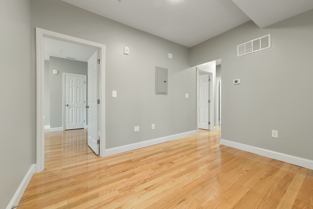 34 Fessenden Street, Unit 2 Boston, MA 02126 - Photo 5 of 21 a view of an empty room with wooden floor