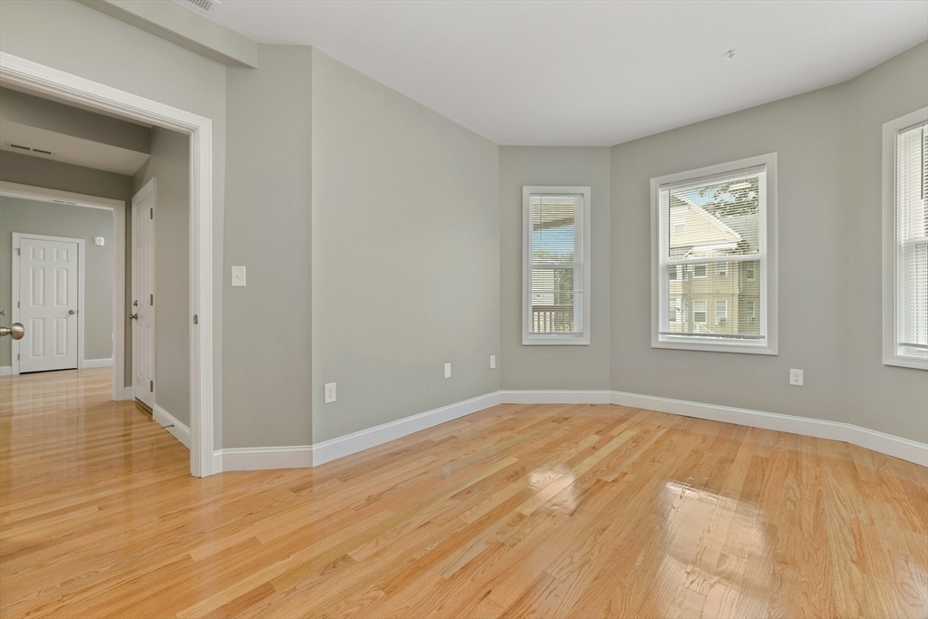 34 Fessenden Street, Unit 2 Boston, MA 02126 - Photo 7 of 21 a view of an empty room with wooden floor and a window