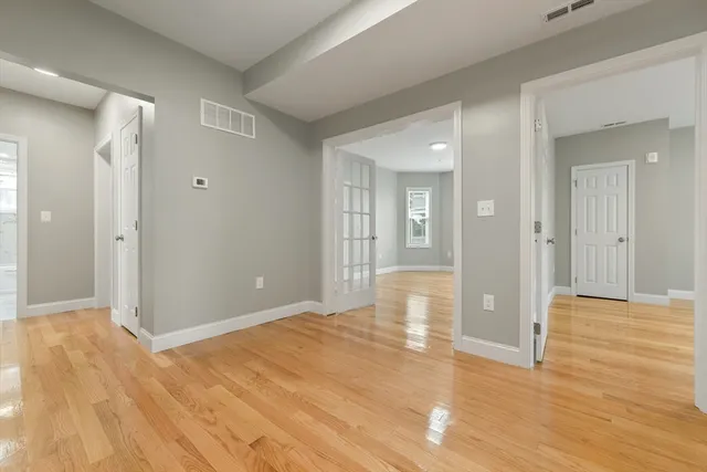 a view of livingroom with wooden floor and bathroom