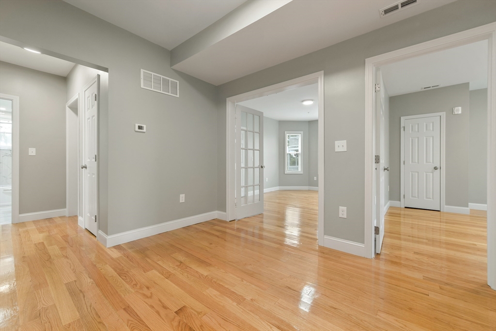 34 Fessenden Street, Unit 2 Boston, MA 02126 - Photo 8 of 21 a view of livingroom with wooden floor and bathroom