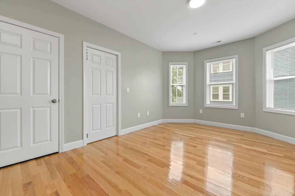 34 Fessenden Street, Unit 2 Boston, MA 02126 - Photo 10 of 21 a view of an empty room with wooden floor and a window