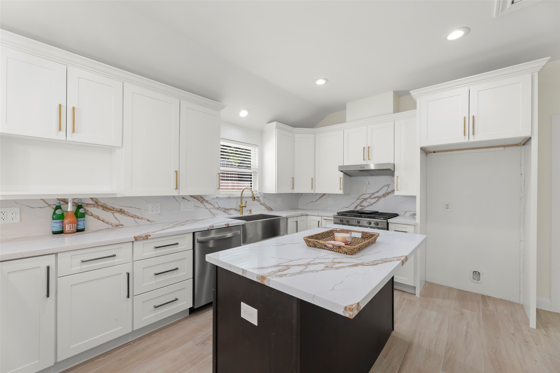 729 Caperton Street Houston, TX 77022 - Photo 12 of 42 a kitchen with a sink a stove and cabinets