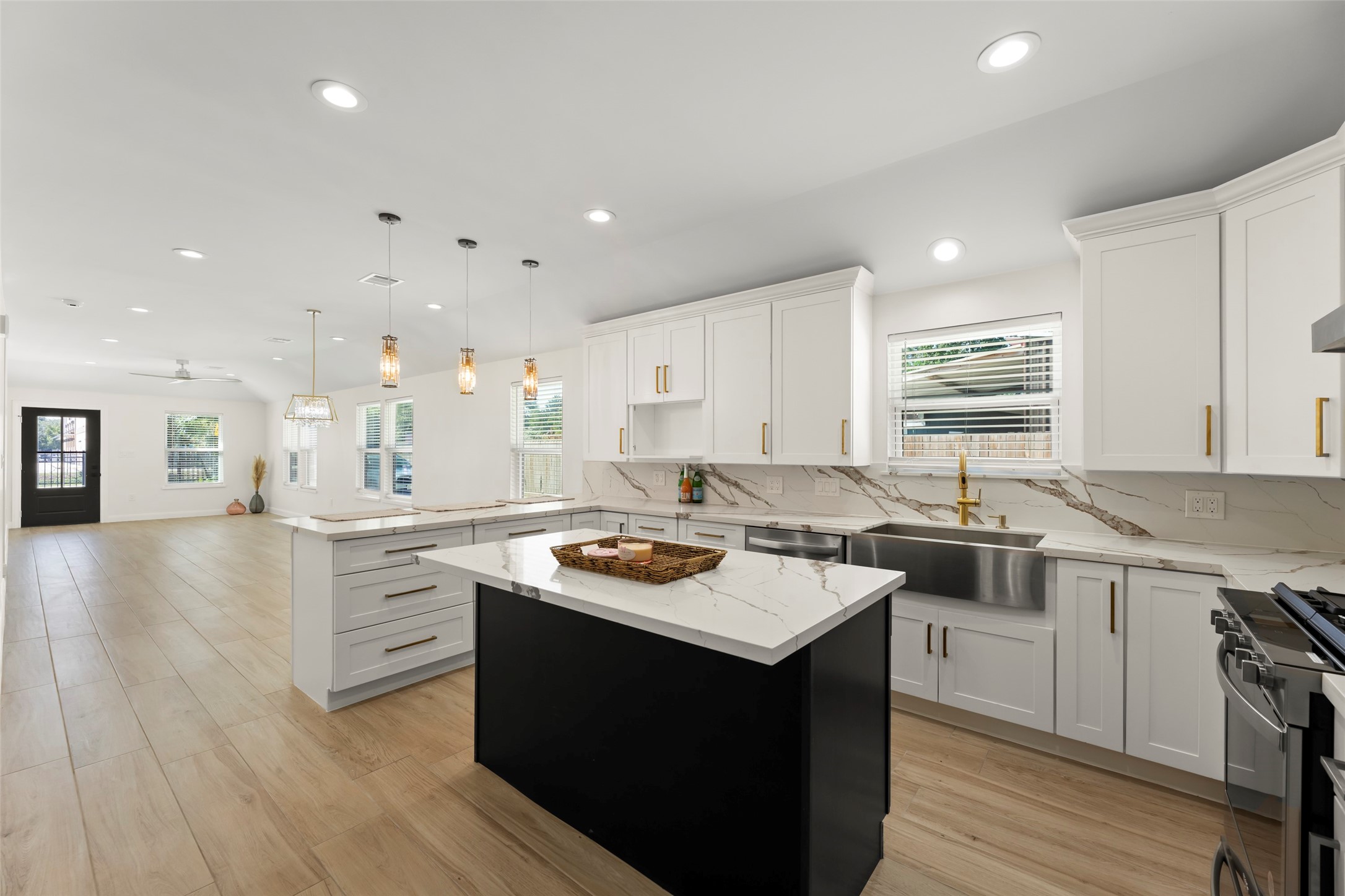 729 Caperton Street Houston, TX 77022 - Photo 13 of 42 a kitchen with a stove a sink a refrigerator and cabinets