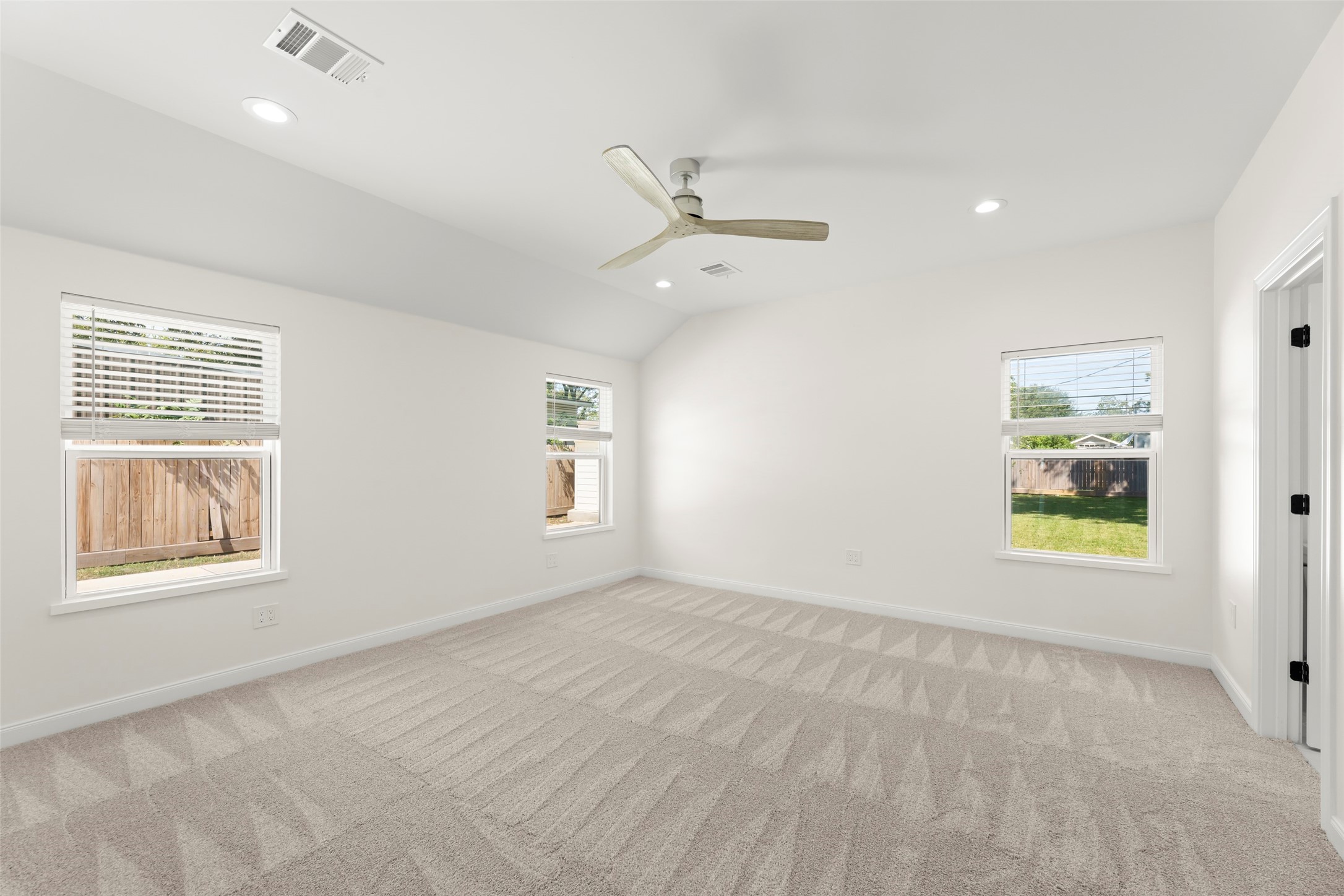 729 Caperton Street Houston, TX 77022 - Photo 22 of 42 an empty room with windows and ceiling fan