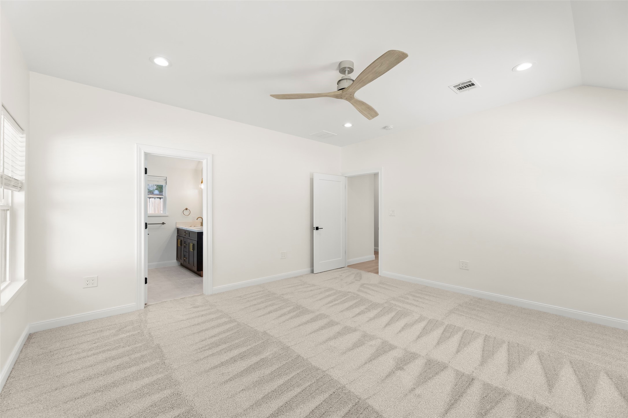 729 Caperton Street Houston, TX 77022 - Photo 23 of 42 a view of an empty room with wooden floor and a window