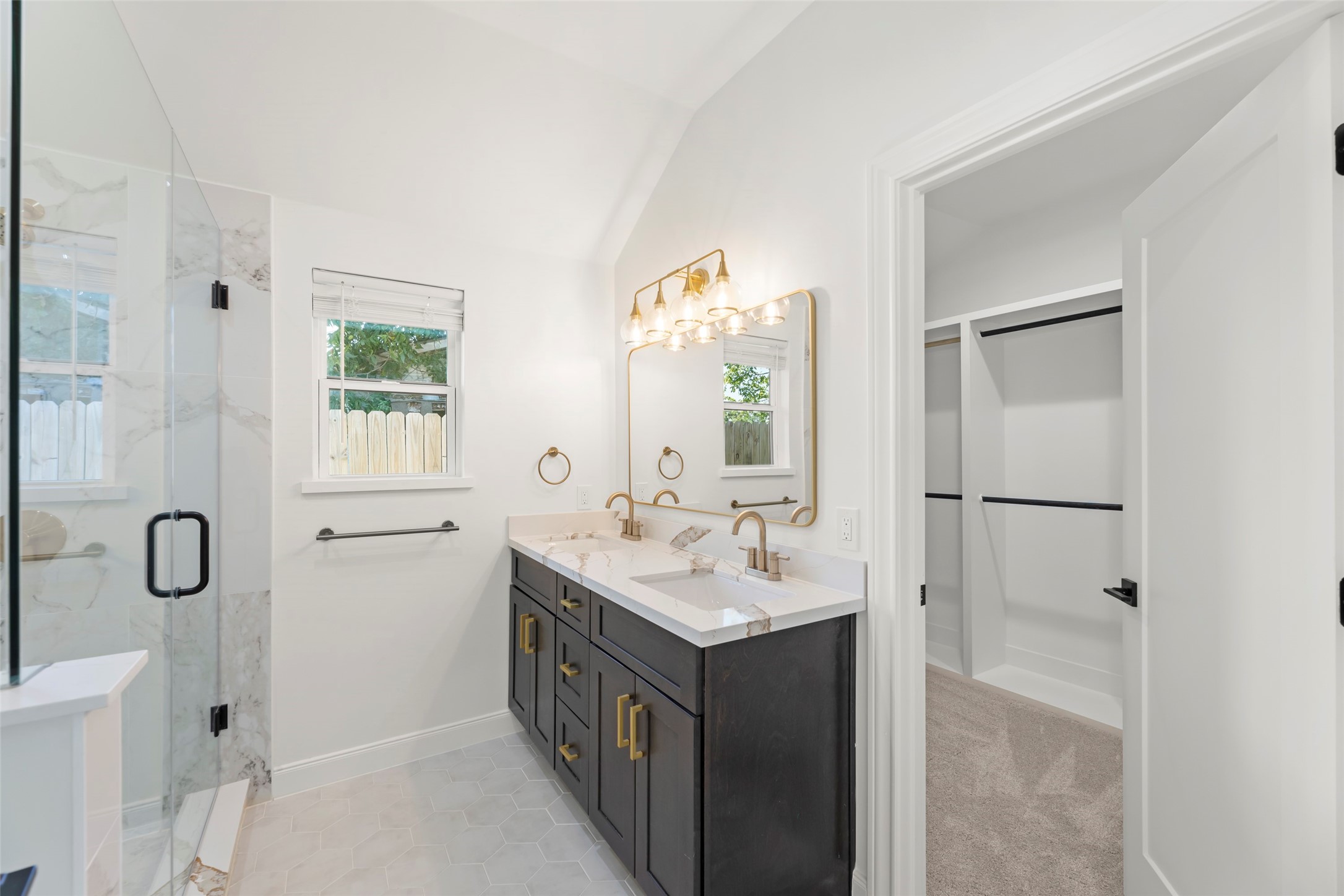 729 Caperton Street Houston, TX 77022 - Photo 24 of 42 a bathroom with a double vanity sink a mirror and a shower