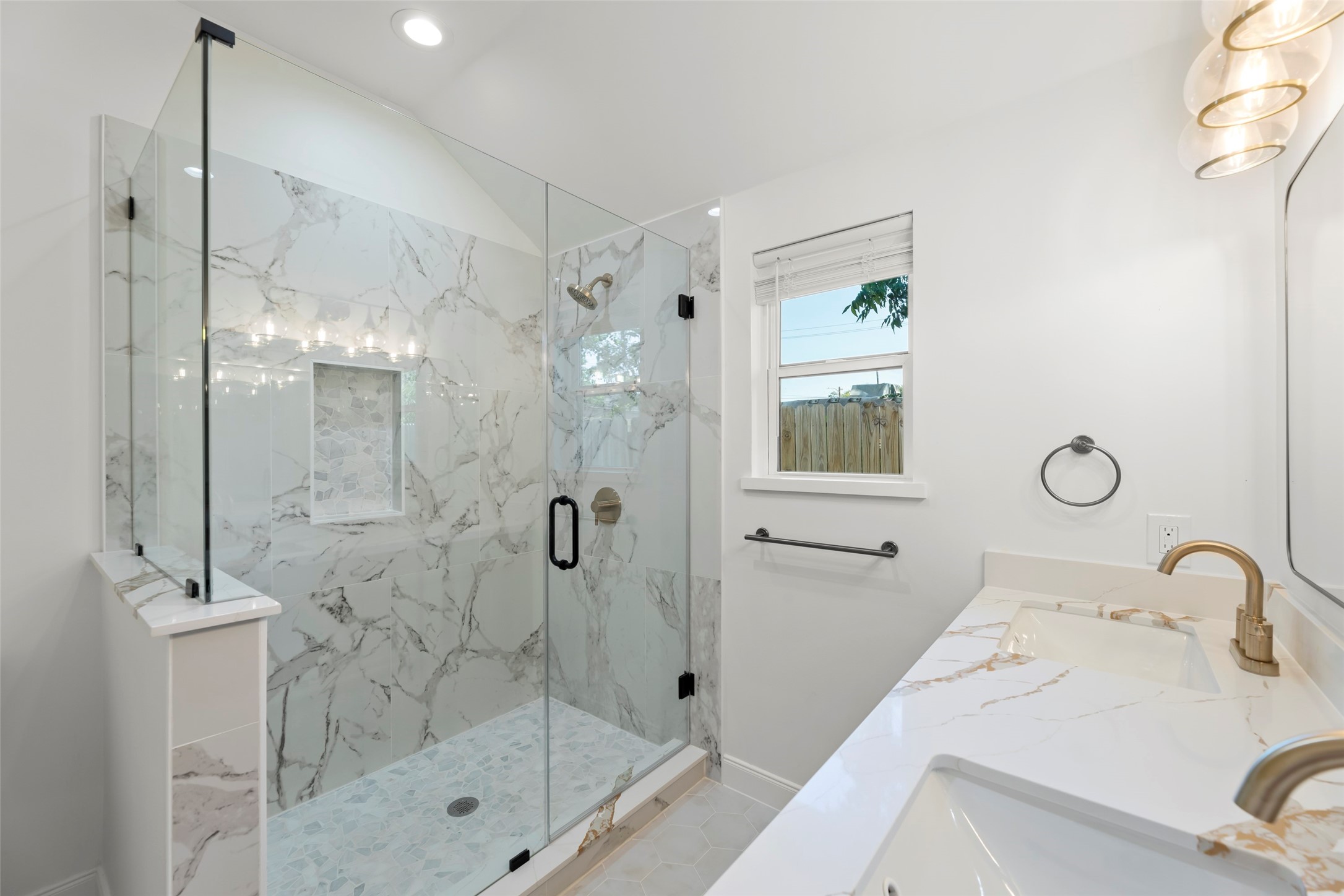 729 Caperton Street Houston, TX 77022 - Photo 25 of 42 a bathroom with a shower sink and mirror